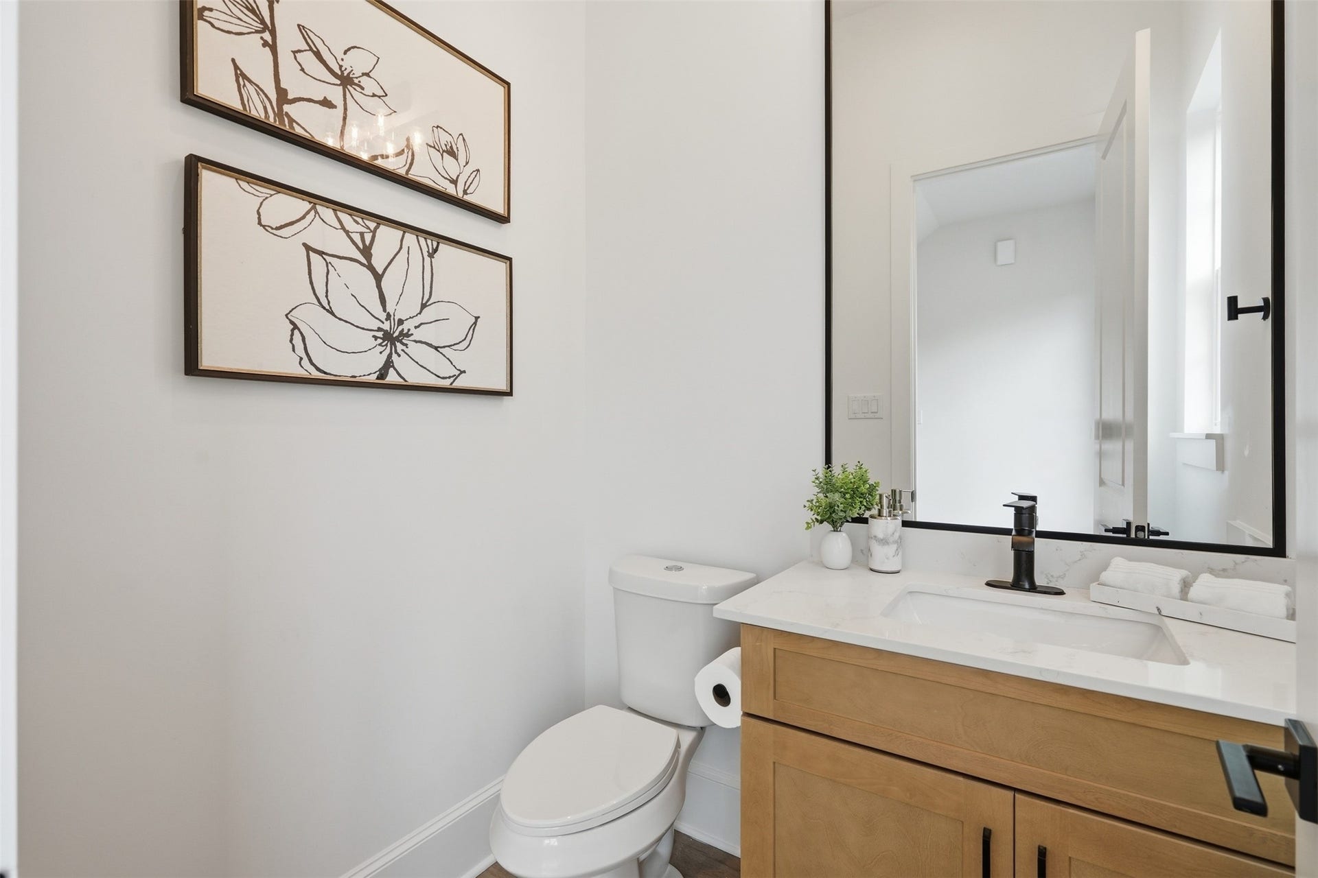 2111 Nantucket Drive, #C, Houston, TX 77057 A stylish powder bath adds convenience for guests while carrying the home's cohesive finishes throughout.