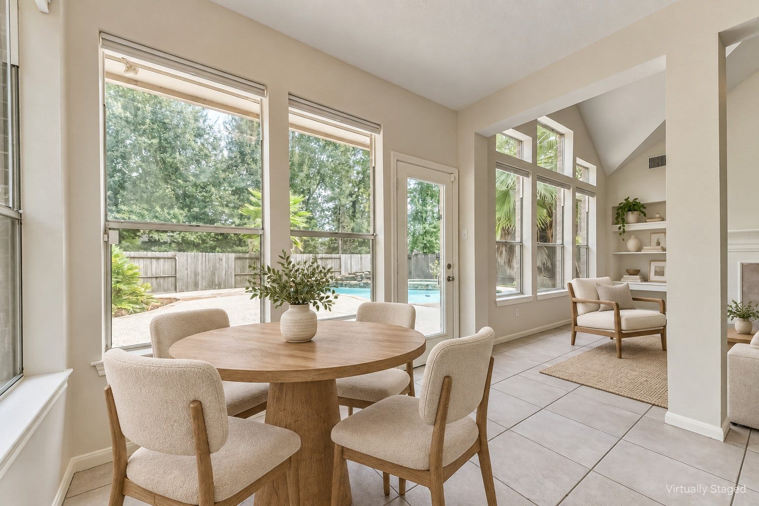 Virtually staged  Morning coffee comes with a pool view in this bright breakfast nook. Easy patio access and a connection to the living room make it an inviting spot for casual meals and weekend gatherings.