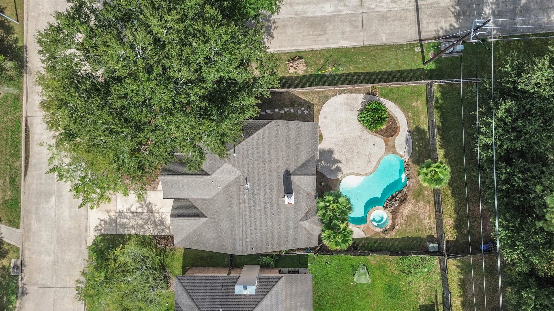 Your weekend plans could be as simple as stepping outside. A freeform pool, adjoining spa and expansive patio offer space for swimming, lounging and gathering around the grillall within the fenced backyard.