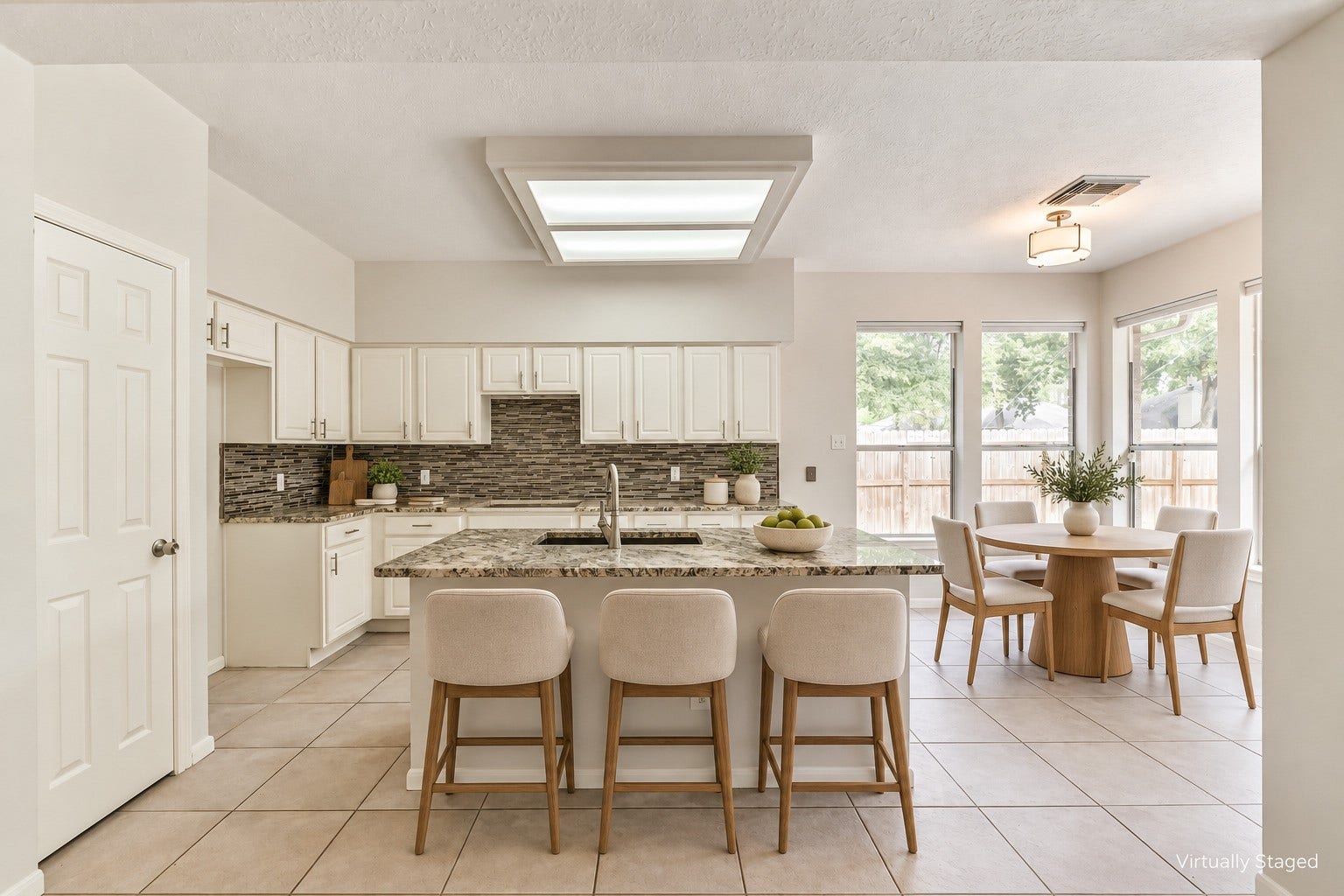 Virtually staged  From a quick bite at the island to a leisurely meal by the windows, this kitchen offers inviting places to connect throughout the day, with ample counter space for preparing and serving meals.