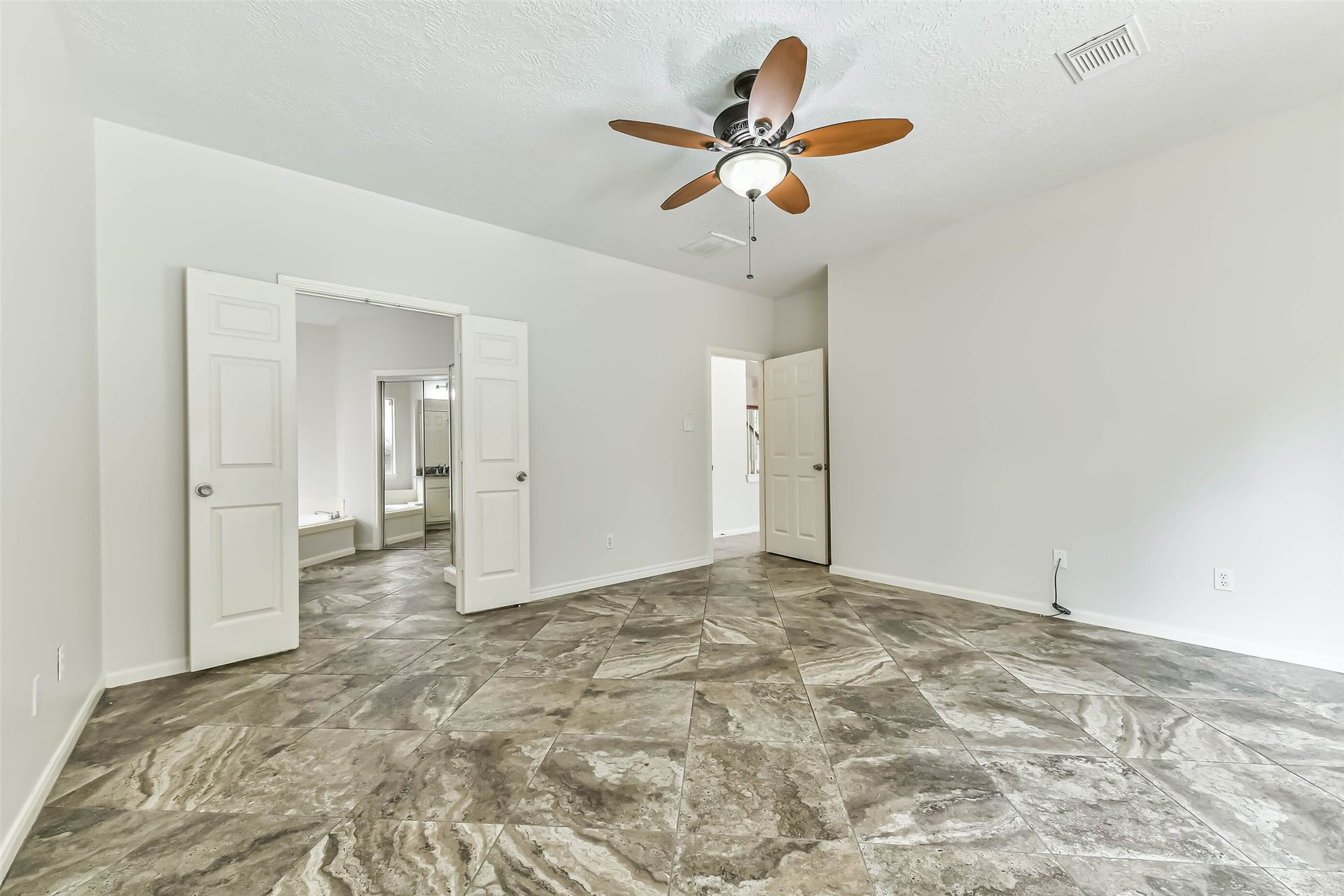 Ease into the day with your bedroom and private bath comfortably connected through double doors. Generous wall space offers flexibility for furniture placement, letting you create a retreat that feels calm, organized and entirely your own.
