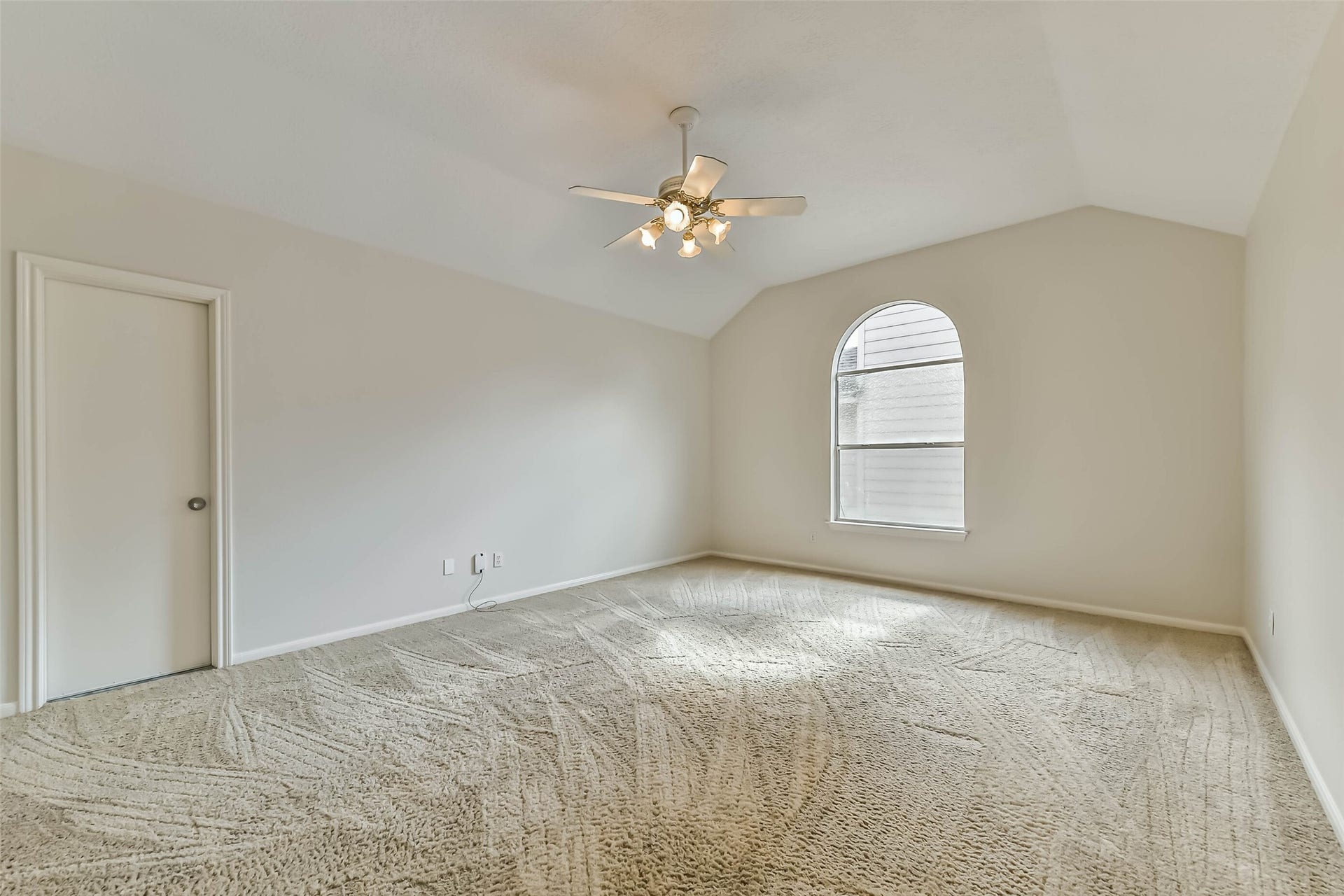 Make room for movie nights, game days or your favorite hobbies. A vaulted ceiling and arched window give this upstairs flex space an airy feel, ready for comfortable seating and a setup that suits the way you spend your downtime.