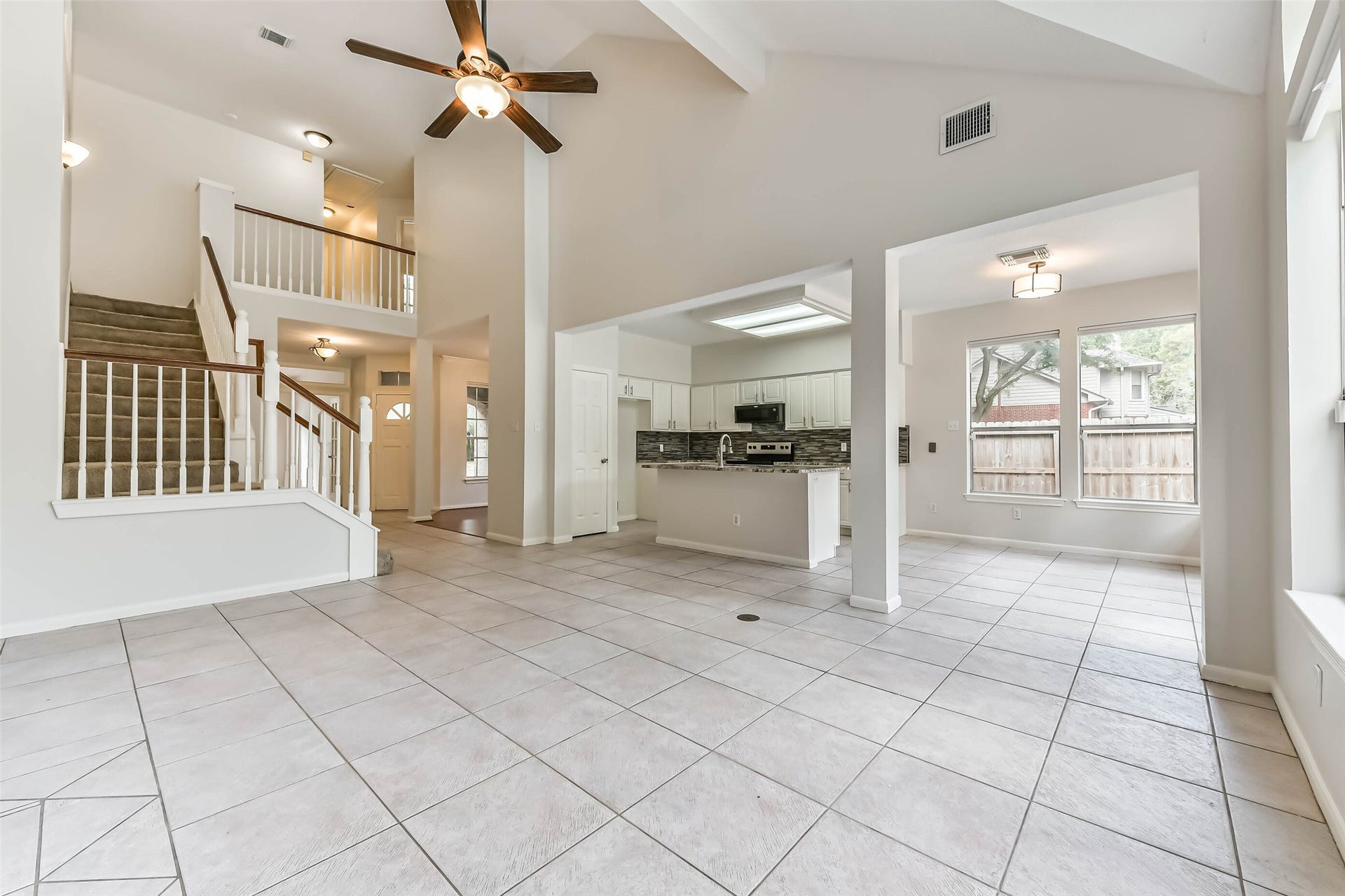 Stay connected to the conversation while preparing dinner or hosting friends. The kitchen, breakfast area and living room flow together beneath soaring ceilings, creating an inviting setting for both everyday routines and casual entertaining.