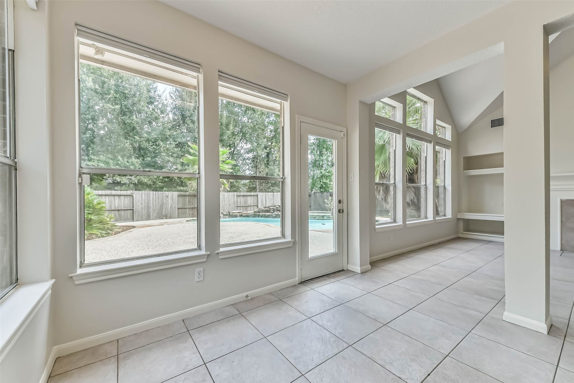 Enjoy a backyard view that brings a touch of getaway to everyday meals. The breakfast area opens to the living room, while the poolside patio sits just beyond the door for an easy transition from indoor dining to outdoor gathering.