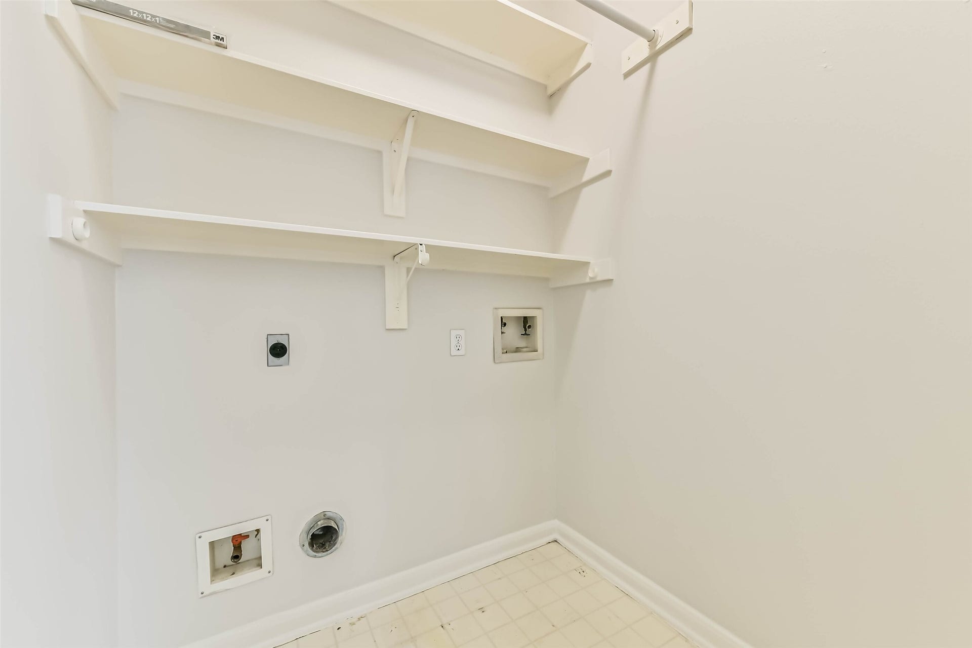 Keep everyday chores contained in a dedicated laundry space. Built-in shelves provide a convenient home for detergents and supplies, while the overhead hanging rod offers a place to air-dry clothing or hang freshly pressed pieces.