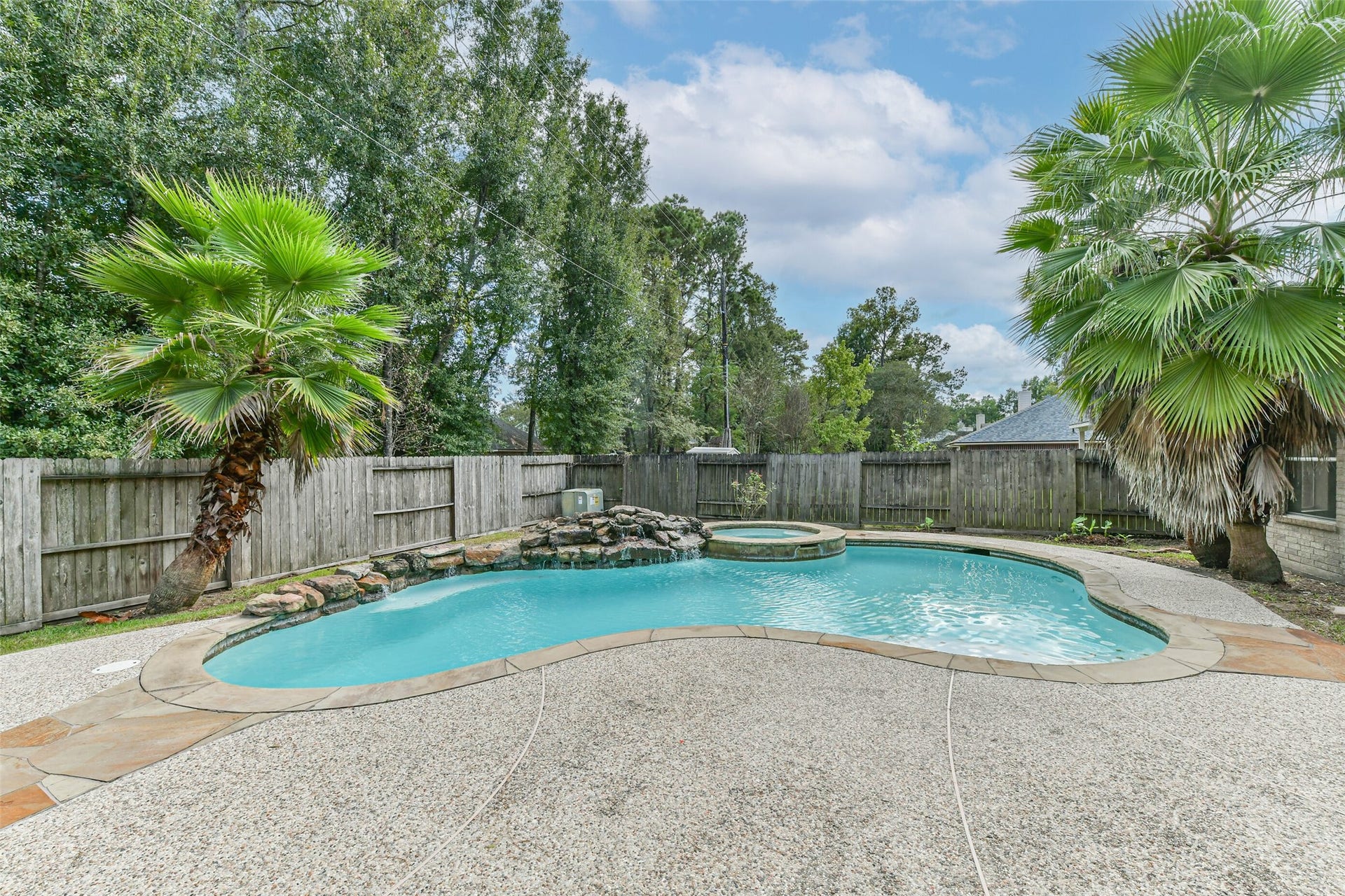 Let the sound of the rock waterfall set the mood for a slower afternoon. The freeform pool and adjoining spa bring a vacation feel to your own backyard, ready for refreshing swims and time spent unwinding outdoors.