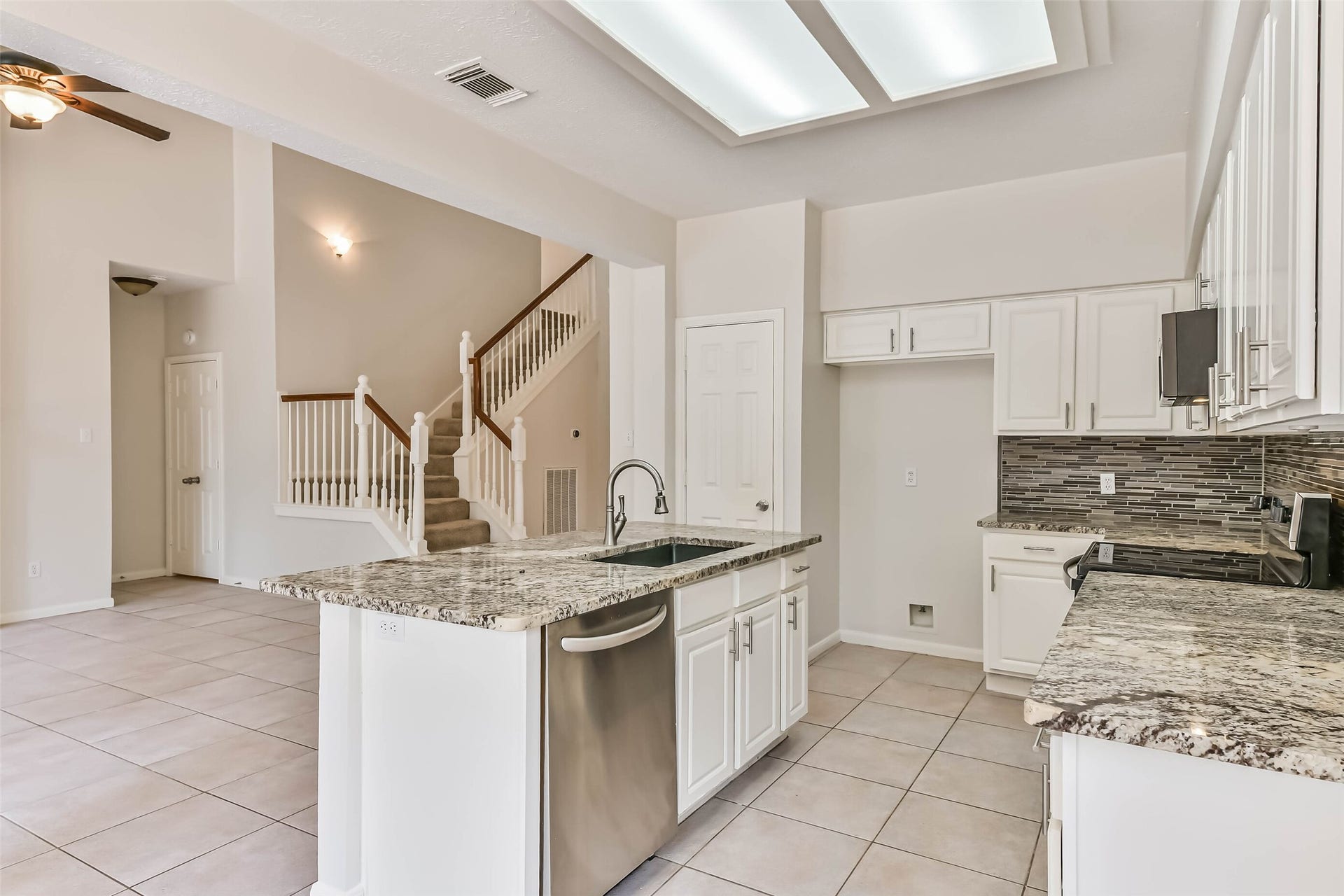 From weeknight meal prep to a spread of appetizers for friends, the generous island gives you room to work while staying connected to the living area. A sink, dishwasher and additional island storage keep everyday tasks conveniently together.