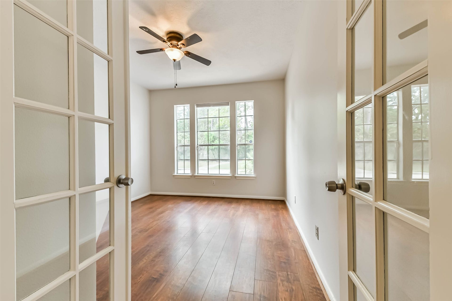 Give your workday a space of its own. Glass-paneled French doors allow separation from the main living areas without sacrificing light, while tall front windows create an appealing setting for focused work, reading or creative projects.
