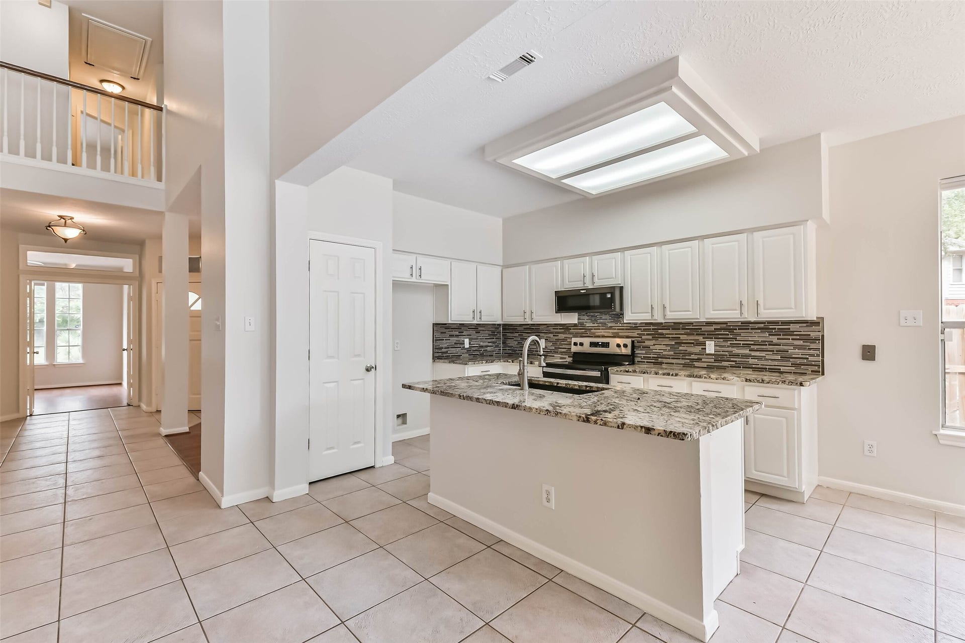 A kitchen designed to keep the cook part of the gathering. The central island provides a convenient place to prep and serve, while plentiful cabinetry helps keep everyday essentials organized and the open layout connects you to the surrounding living spaces.