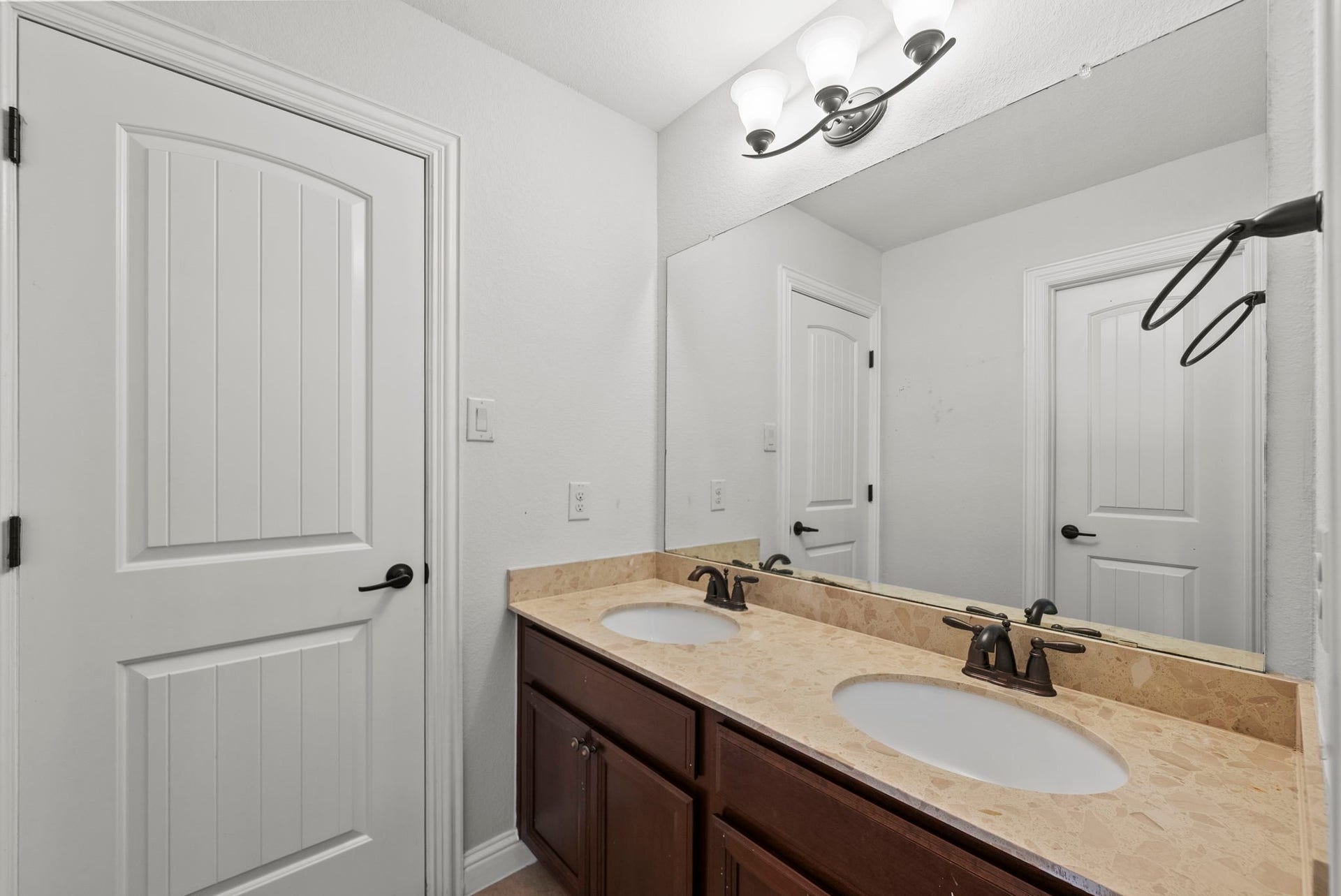 26111 Tintagel Lane, Kingwood, TX 77339 Convenient Jack-and-Jill bathroom features a dual-sink vanity with elegant counters, practical style for busy mornings!