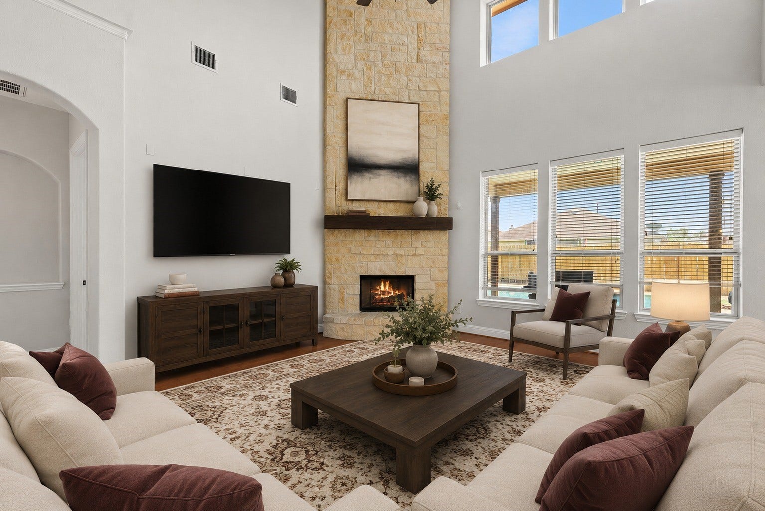 26111 Tintagel Lane, Kingwood, TX 77339 Virtually Stagged - Light filled living room stuns with soaring ceilings, a striking floor-to-ceiling stone fireplace, and windows framing serene backyard pool views!