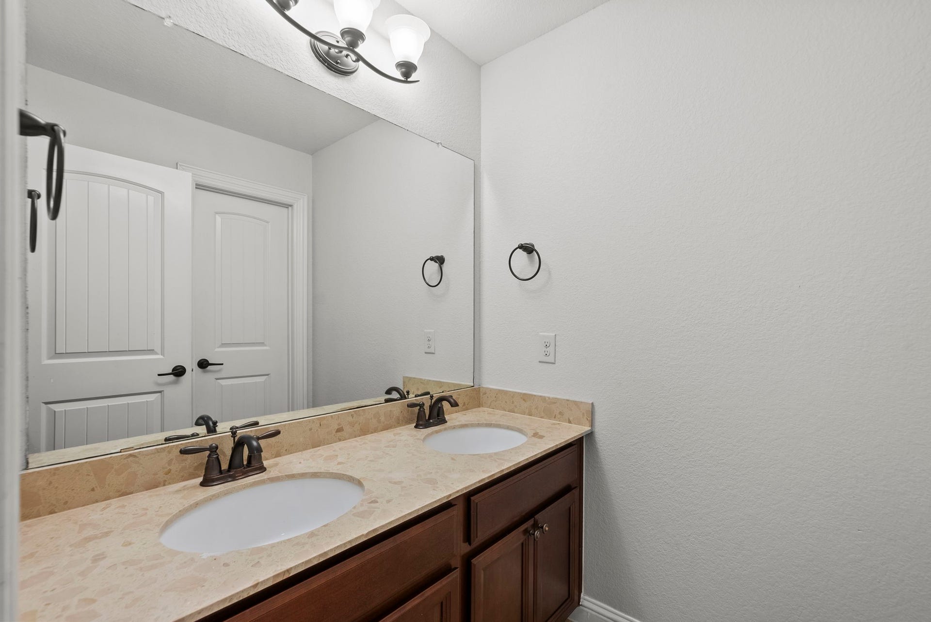 26111 Tintagel Lane, Kingwood, TX 77339 Convenient Jack-and-Jill style bath features double vanity sinks and rich counters, ideally designed for busy mornings!