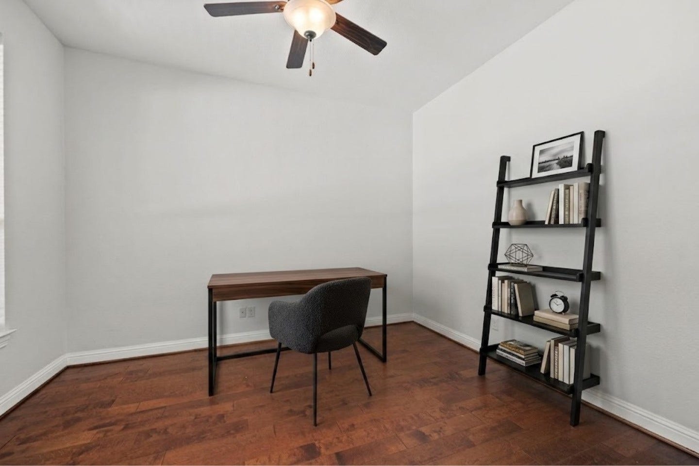 26111 Tintagel Lane, Kingwood, TX 77339 Virtually Stagged - Spacious study room featuring rich hardwood floors and a ceiling fan.