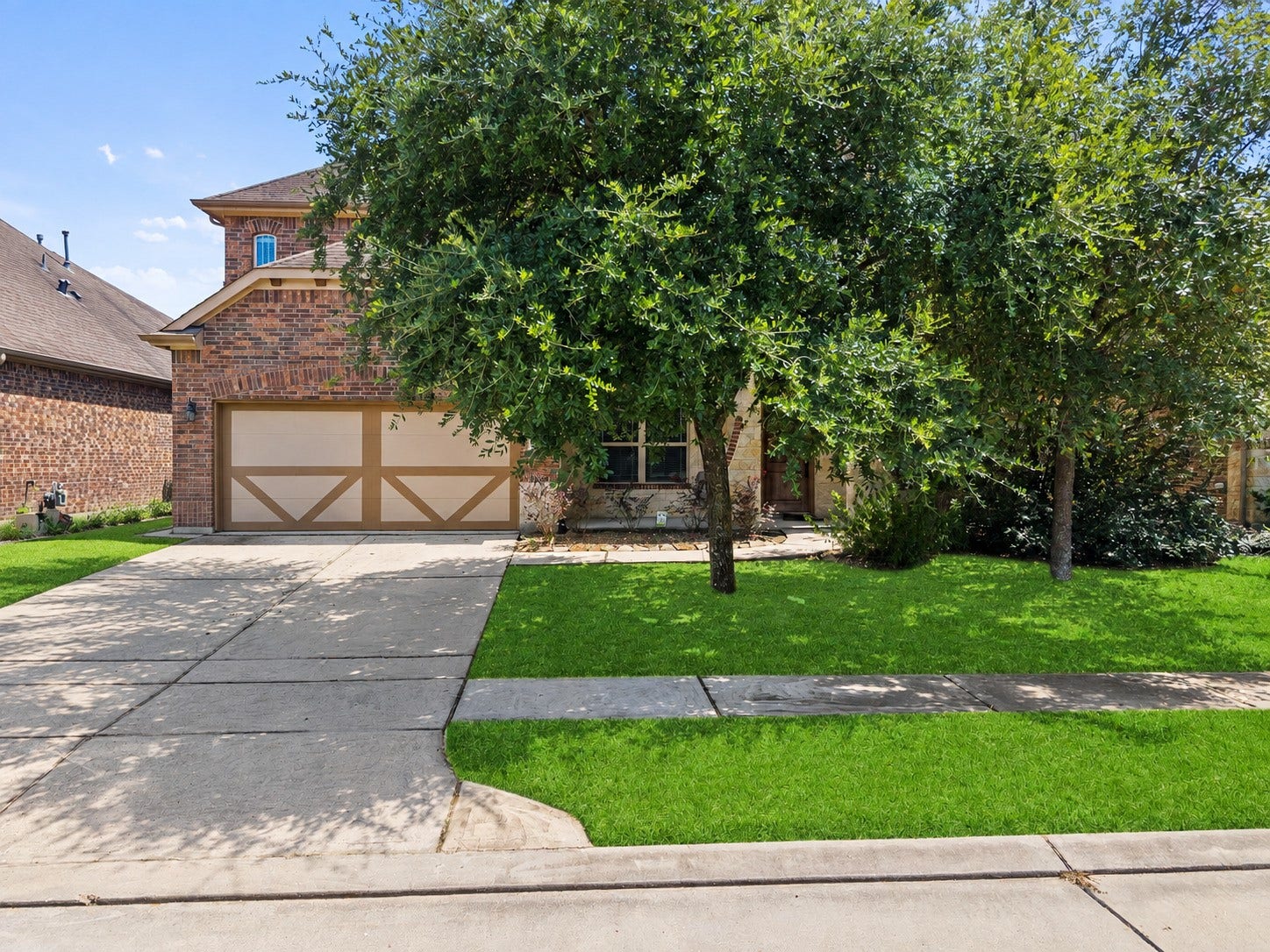 26111 Tintagel Lane, Kingwood, TX 77339 Charming brick two-story with a large shade tree anchoring a lush, manicured front lawn and spacious driveway, curb appeal that welcomes you home!