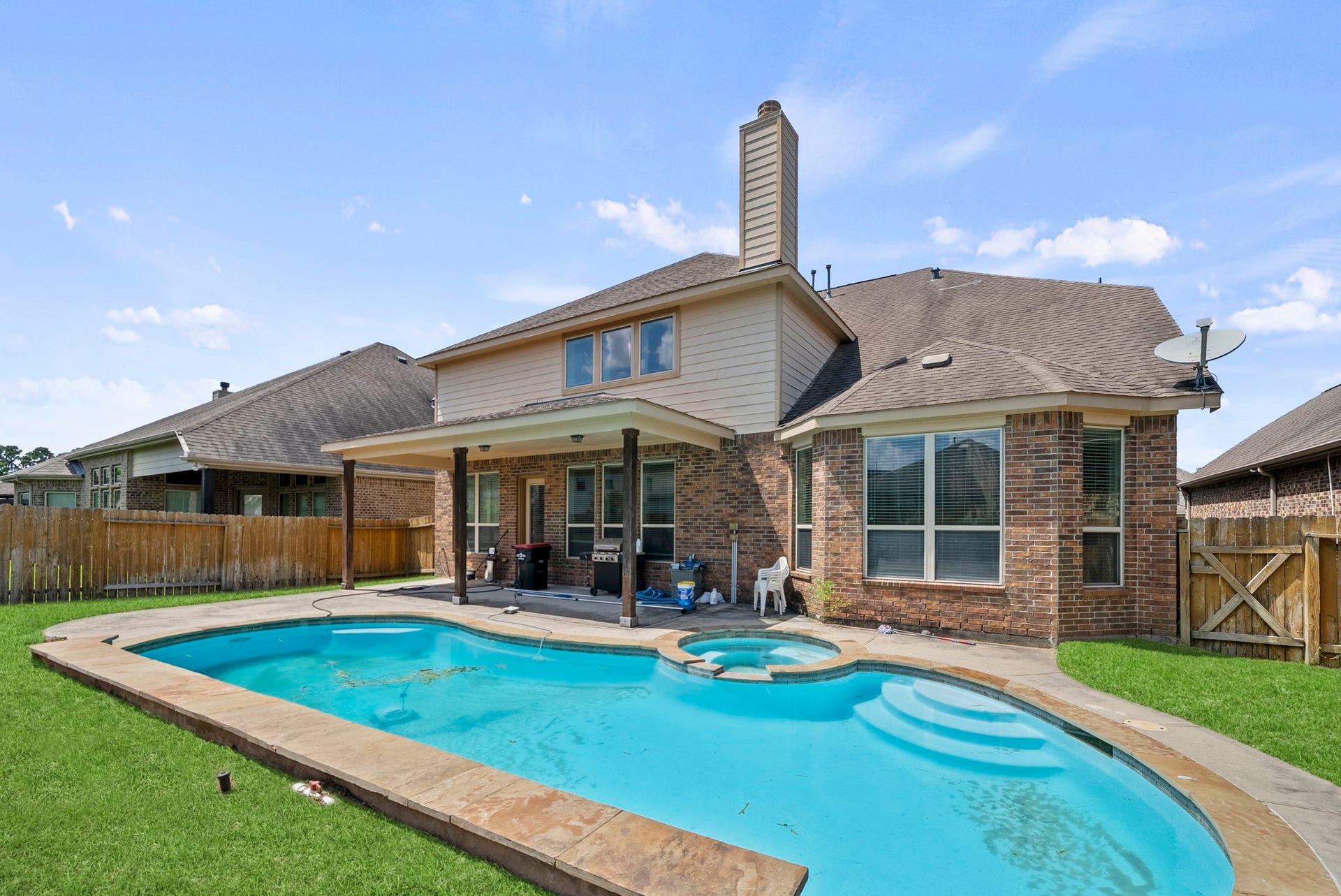 26111 Tintagel Lane, Kingwood, TX 77339 Stunning freeform pool and spa create the ultimate backyard oasis, a covered patio and privacy fencing make it ideal for entertaining and relaxing alike!