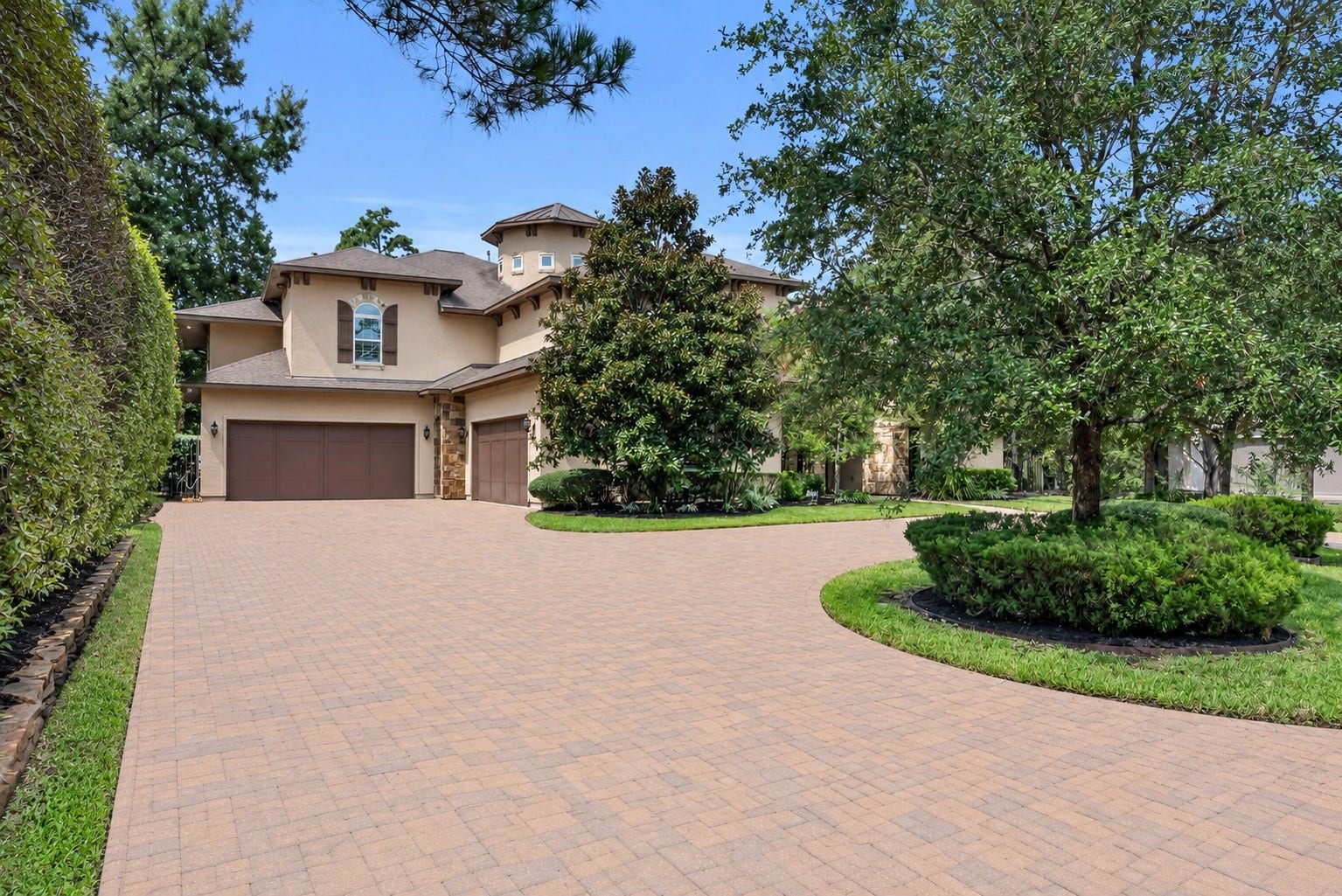 Four-car garage with an expansive circular drive offers exceptional parking and convenience.