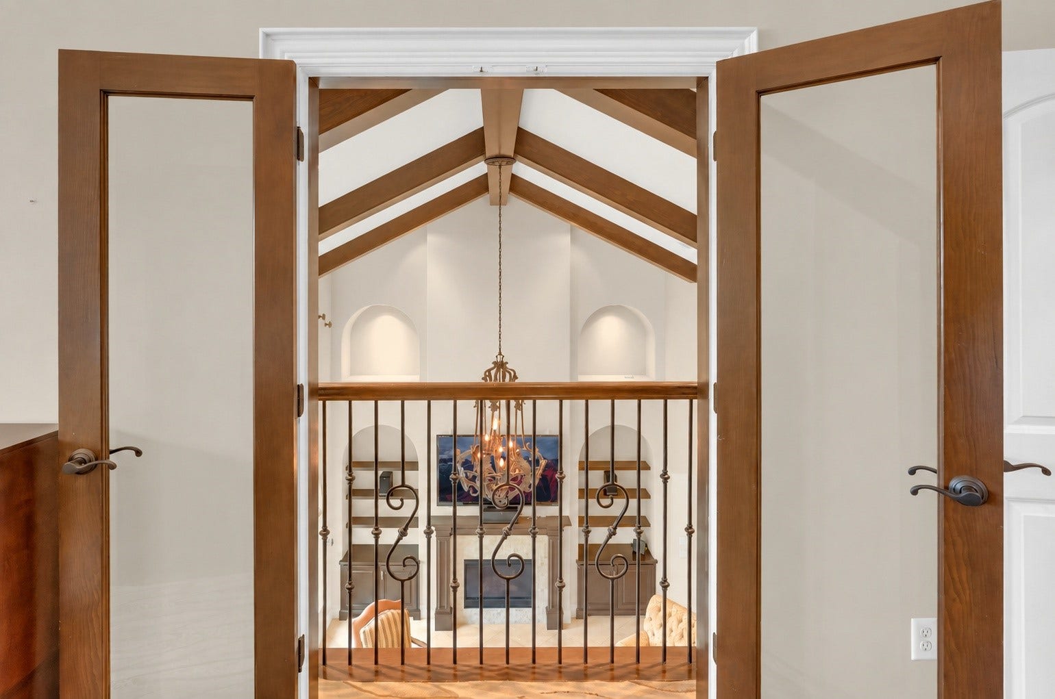 Charming Juliet balcony overlooking the grand living area. Located in the upstairs flex space.