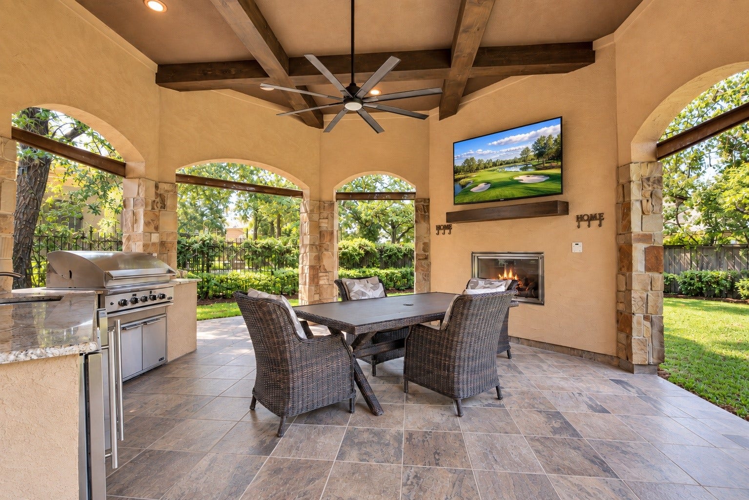 Elegant outdoor loggia with summer kitchen, fireplace and TV.