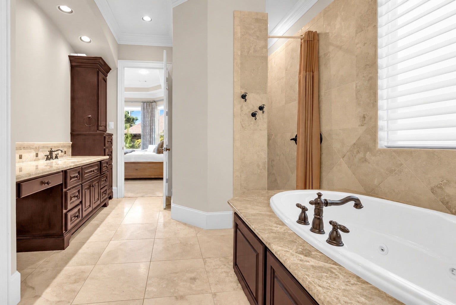Luxurious primary bath with jetted tub and spacious walk-in shower.