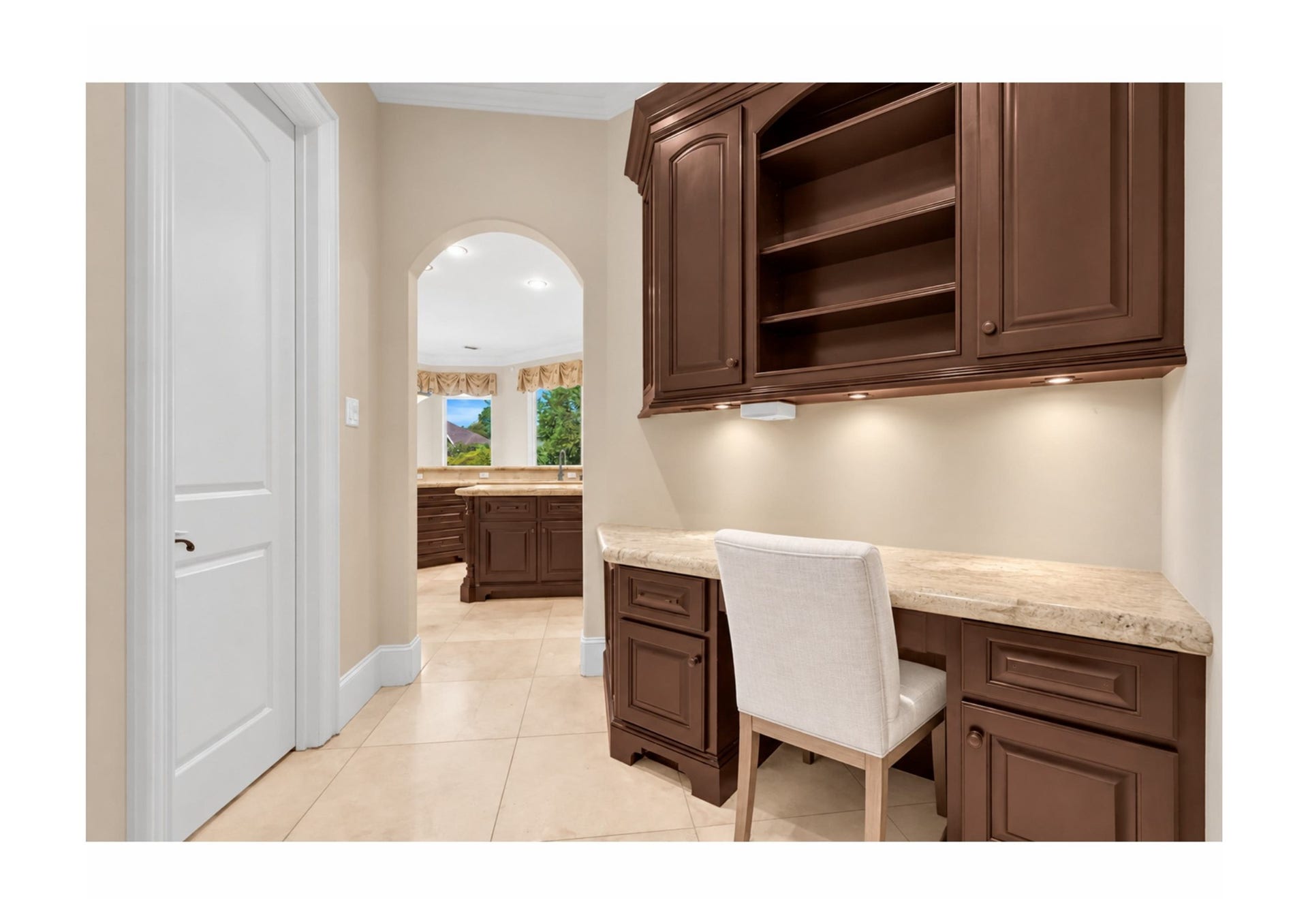 Custom built-in desk area with cabinetry and abundant storage just off the kitchen.