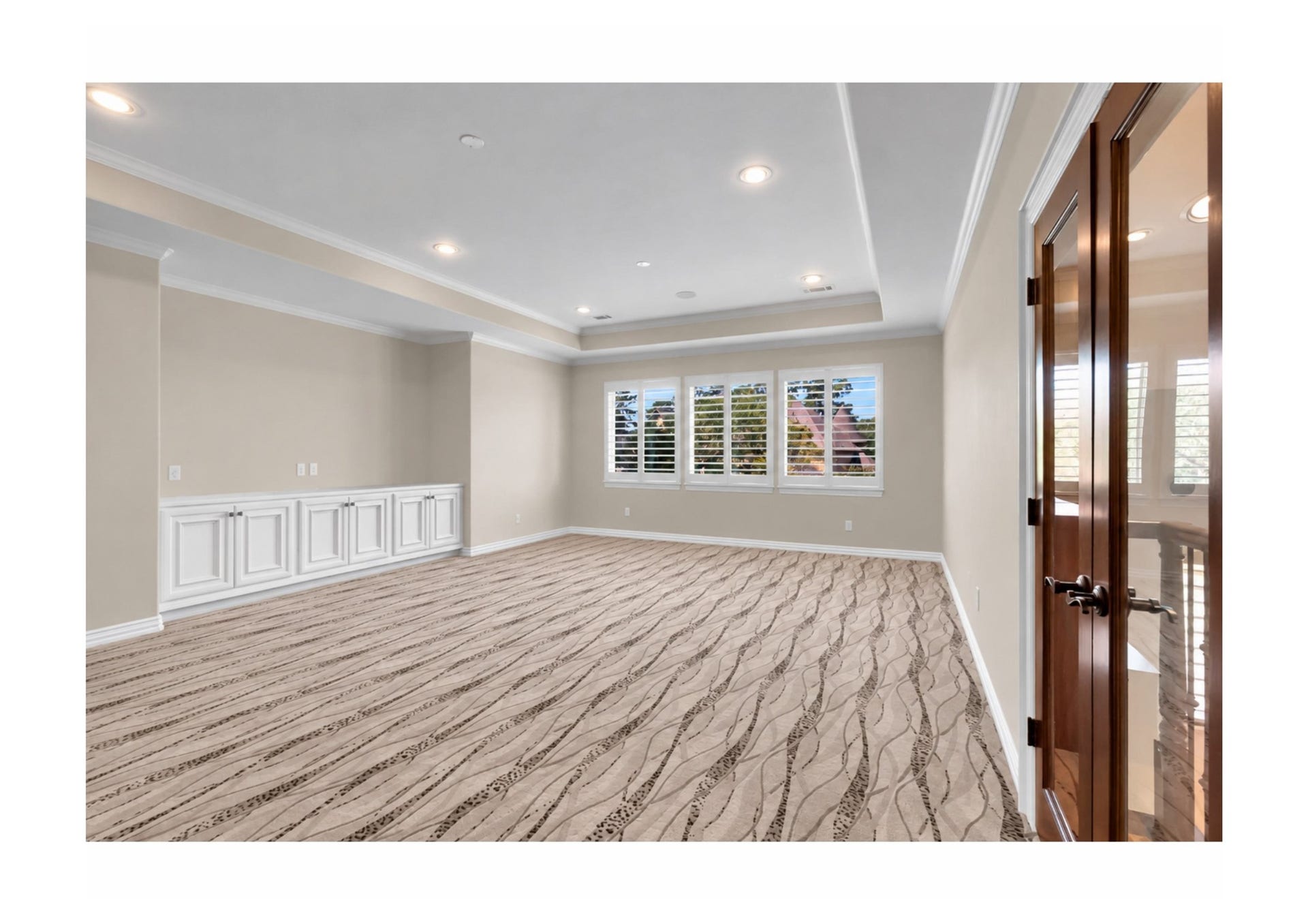 Expansive upstairs flex room with built-in cabinetry and abundant natural light.