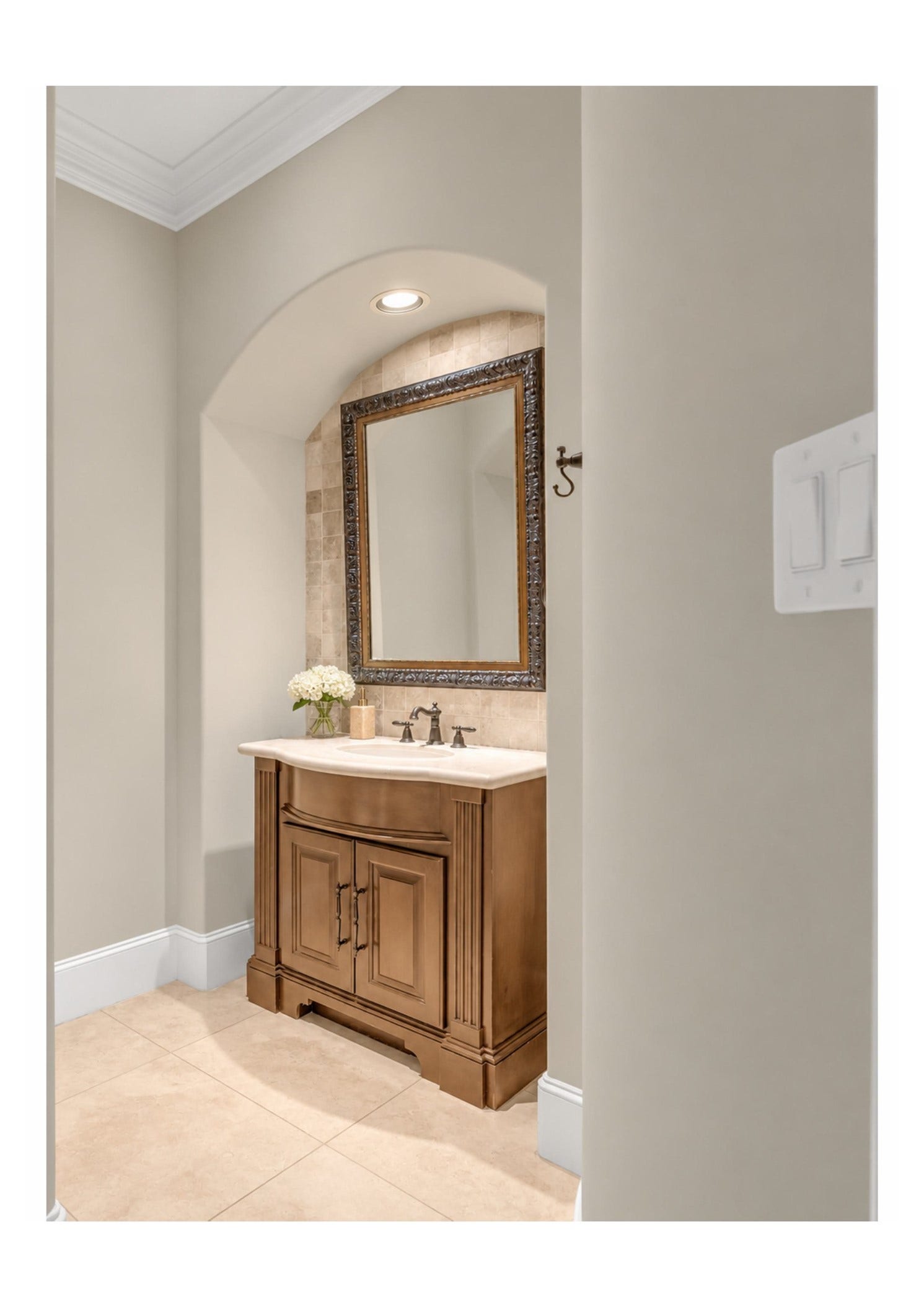 Refined half bath featuring a custom vanity and beautiful finishes.