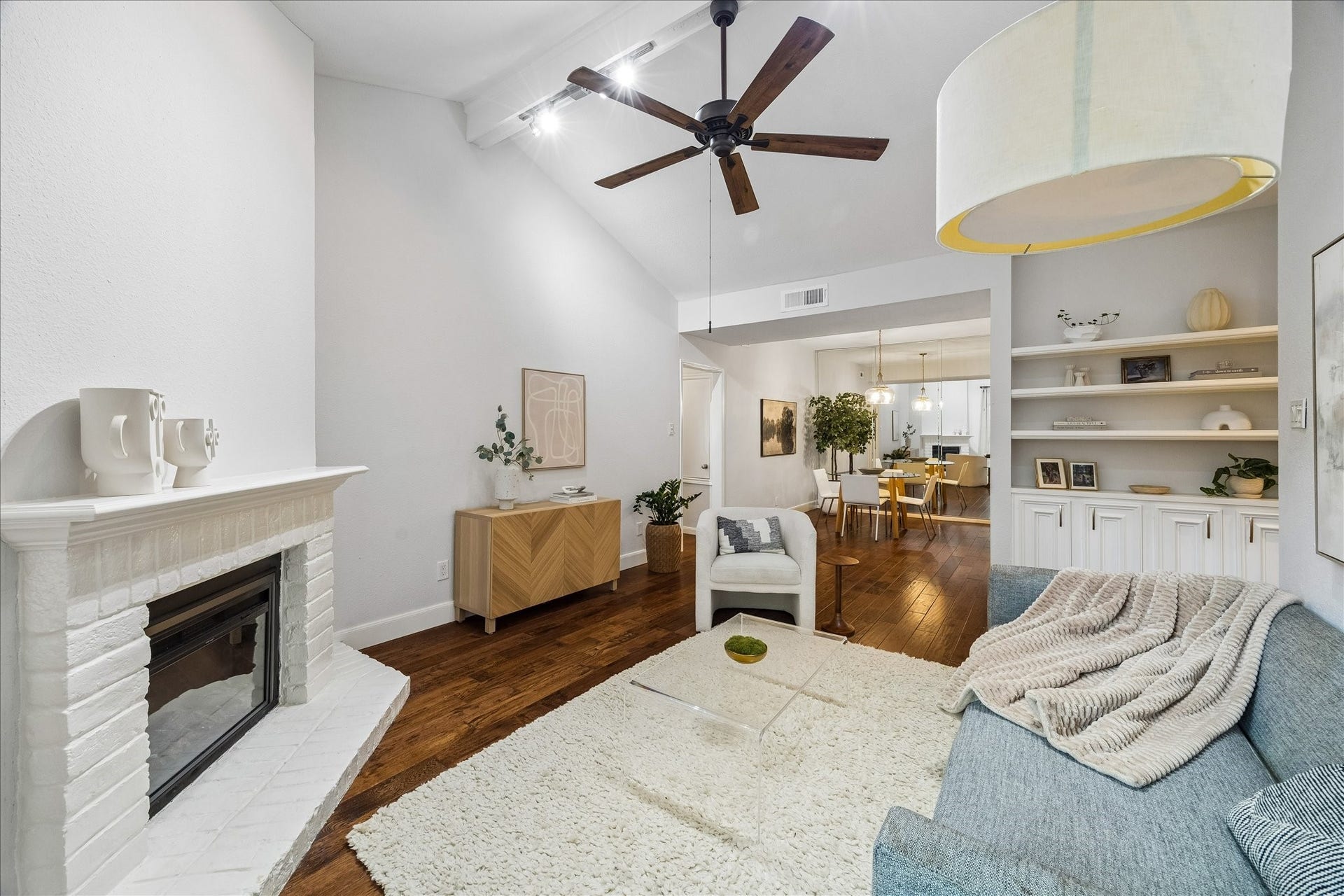 Open-concept living and dining area with engineered hardwood floors and abundant natural light.