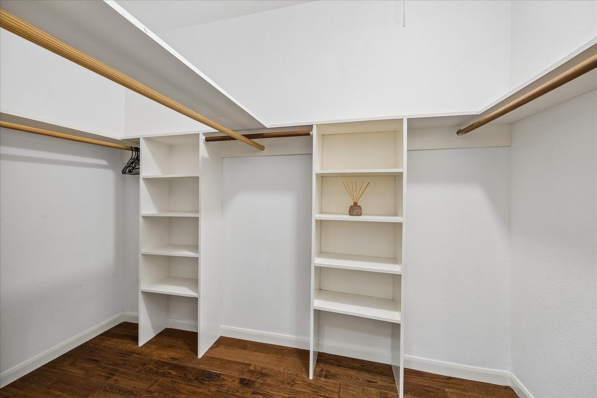 Spacious walk-in closet with built-in shelving and ample storage.