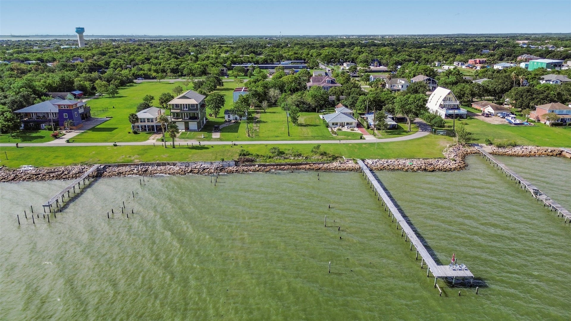 2480 E East Bayshore Drive, San Leon, TX 77539 expansive green lawns, nestled along a serene shoreline with private docks extending into the tranquil waters.