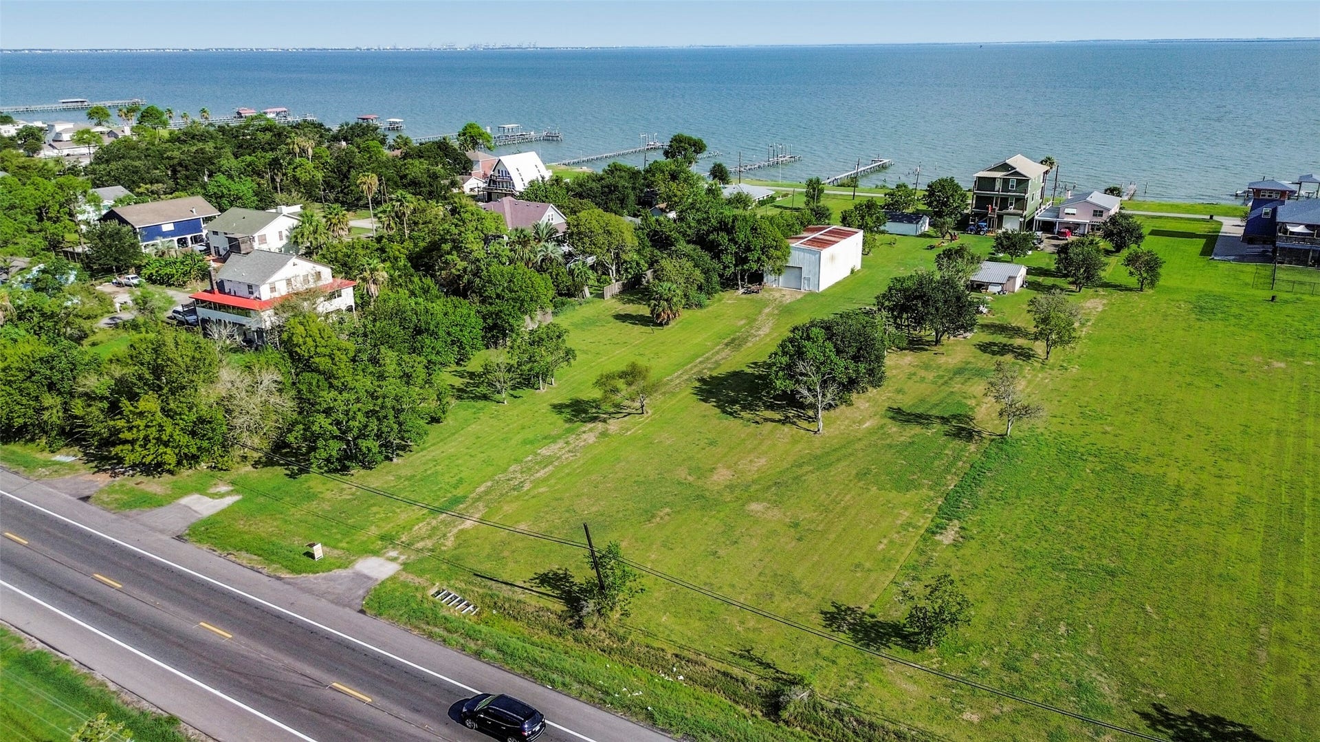 2480 E East Bayshore Drive, San Leon, TX 77539 Prime coastal property with sprawling green spaces, and direct access to serene waterfront views, perfect for building your dream home or getaway retreat.