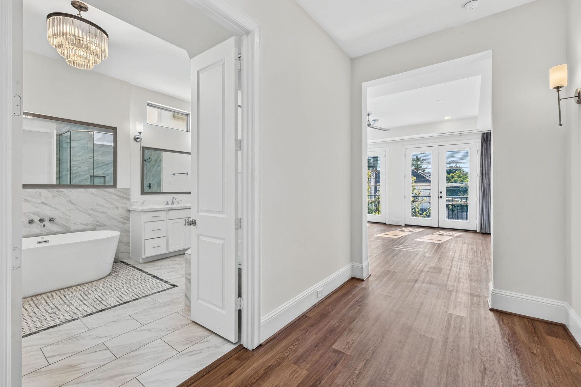 1713 Holman Street, Houston, TX 77004 A private sanctuary: primary bedroom features a dedicated entry foyer leading to a grand ensuite bath with a large glass shower and separate soaking tub.