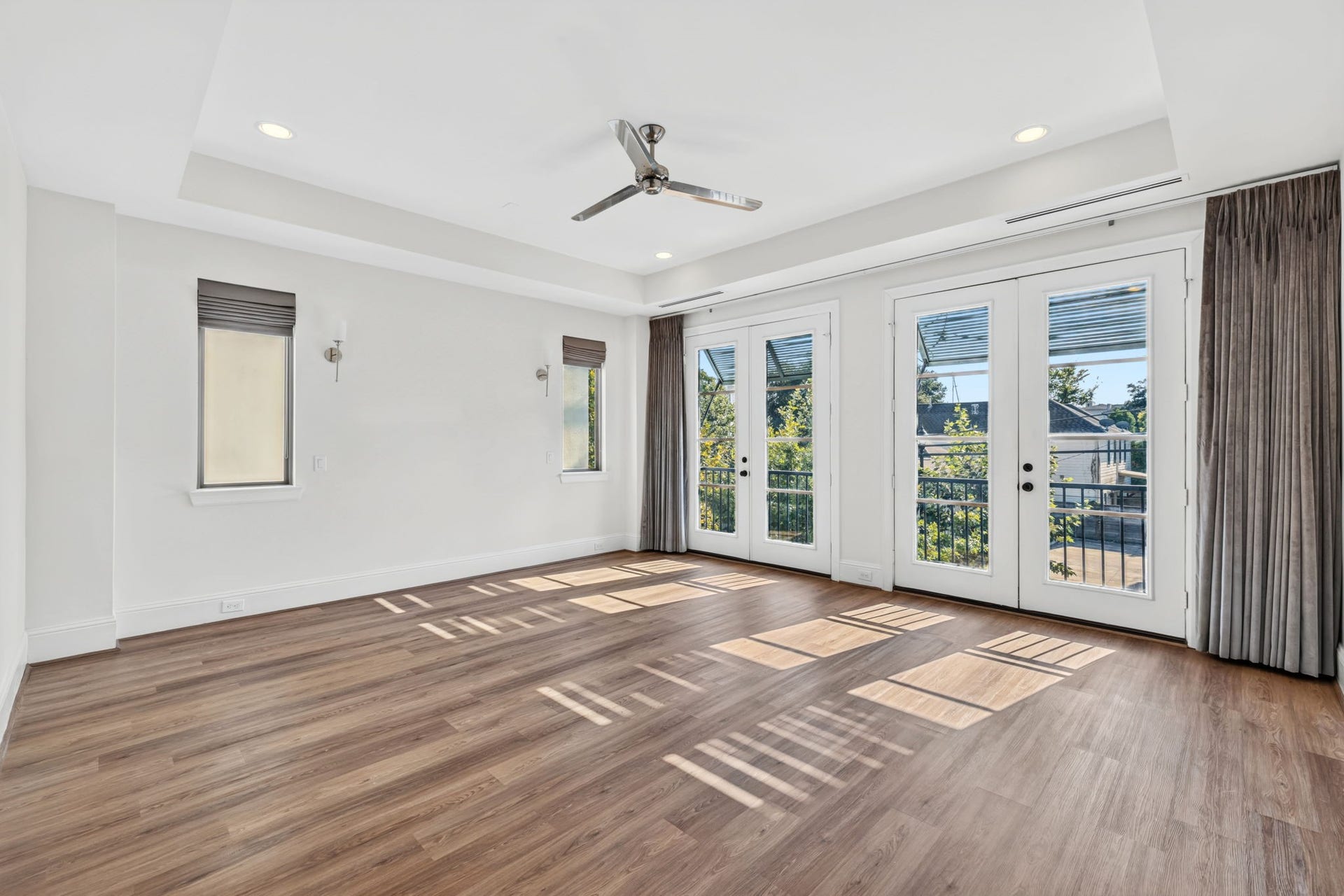 1713 Holman Street, Houston, TX 77004 Broad French doors open to the upper level juliette balcony, flooding the primary suite with light