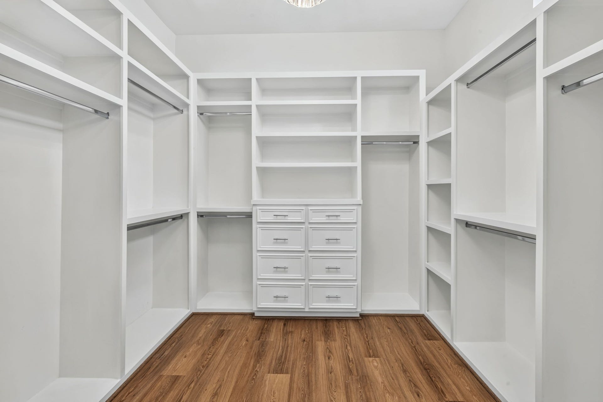 1713 Holman Street, Houston, TX 77004 Step through classic French doors into a remarkably large primary walk-in closet designed with true luxury in mind. Anchored by a stunning statement chandelier.