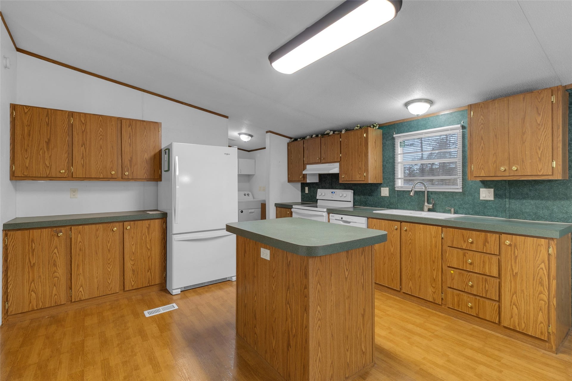 Angled view offering a clearer sense of the kitchens generous space and flow.