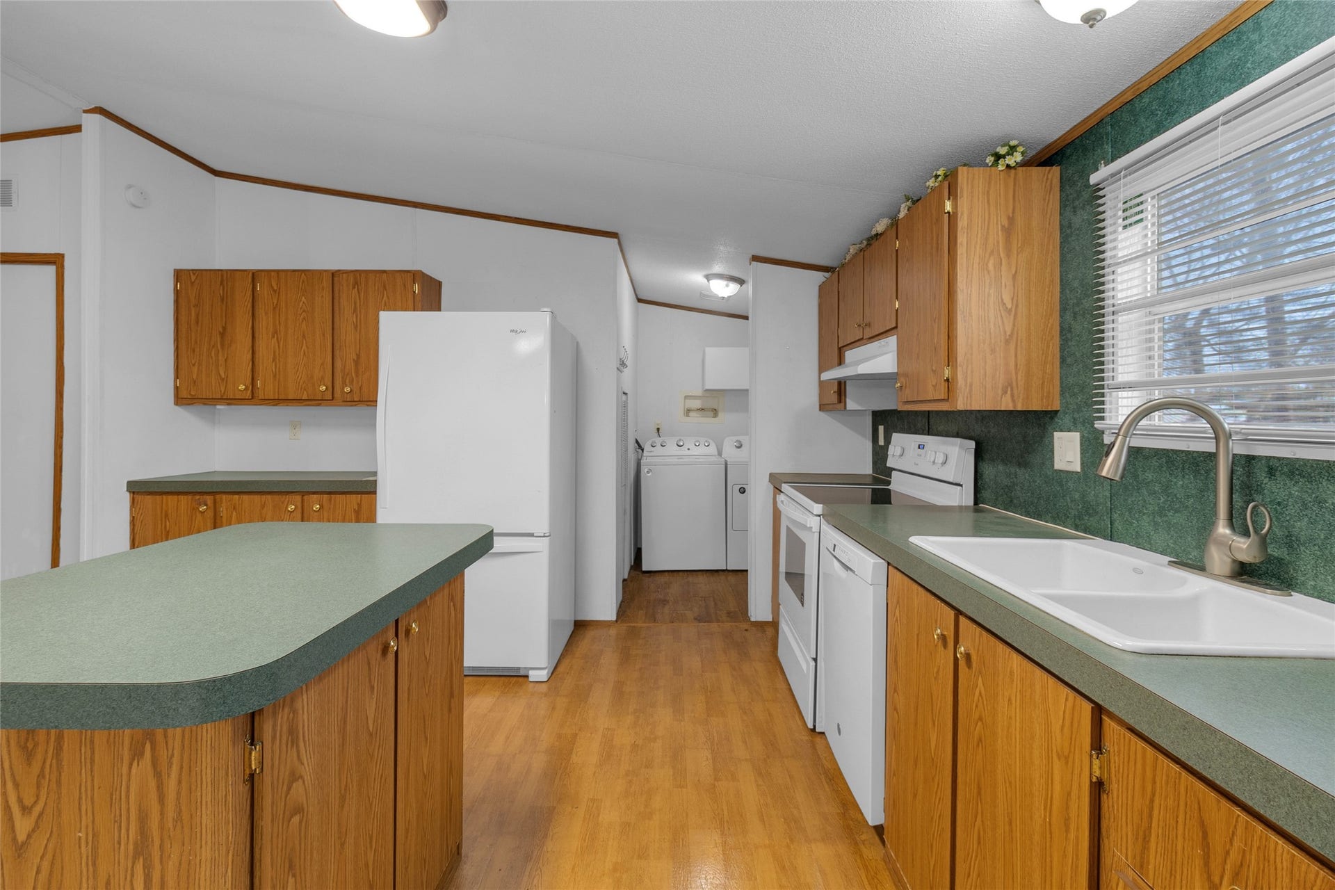 Functional kitchen design with white appliances and a refrigerator.