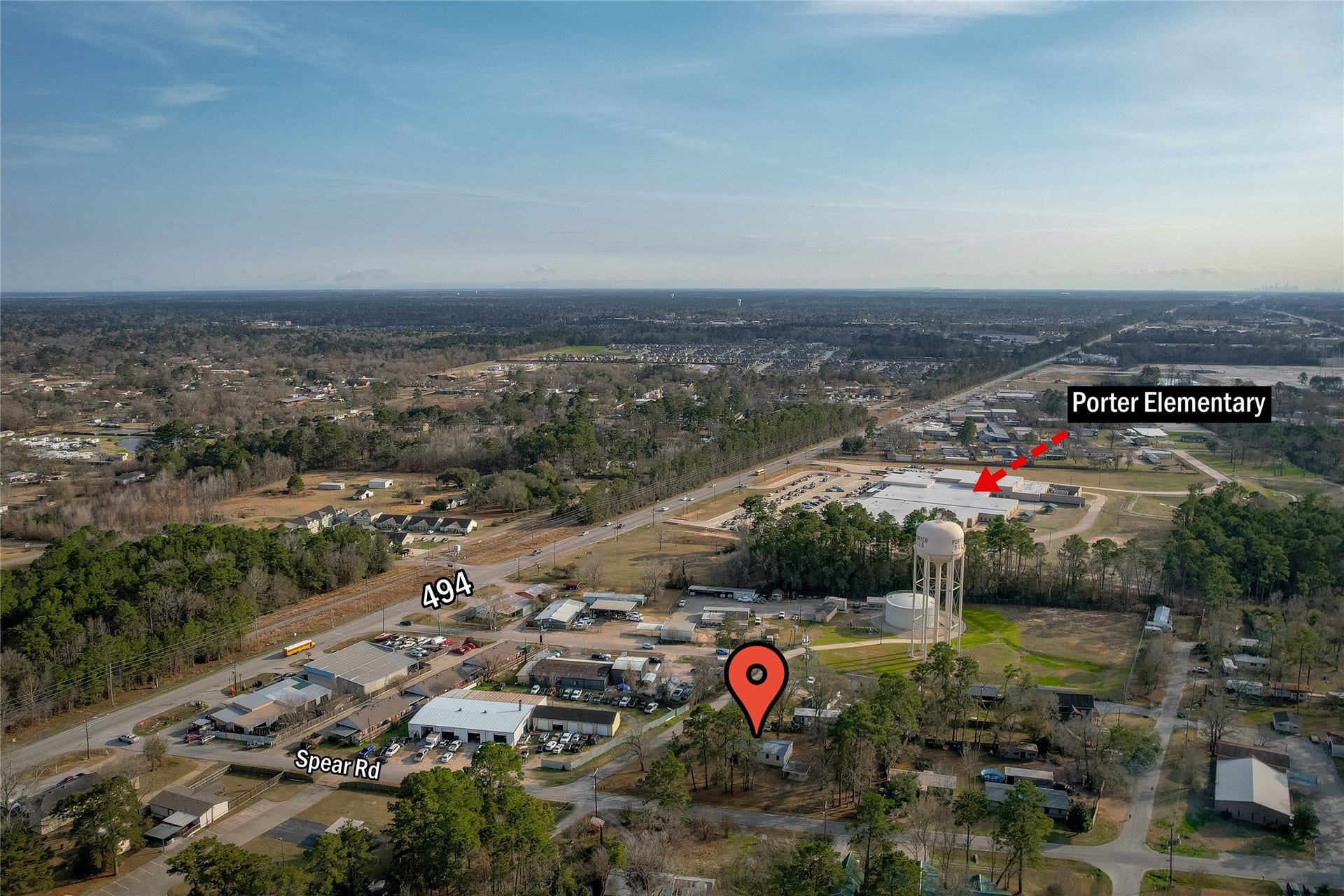 This aerial photo shows a spacious residential area surrounded by greenery. Close proximity to Porter Elementary School. Major roads like 494 and Spear Rd are visible, providing easy access to local amenities.