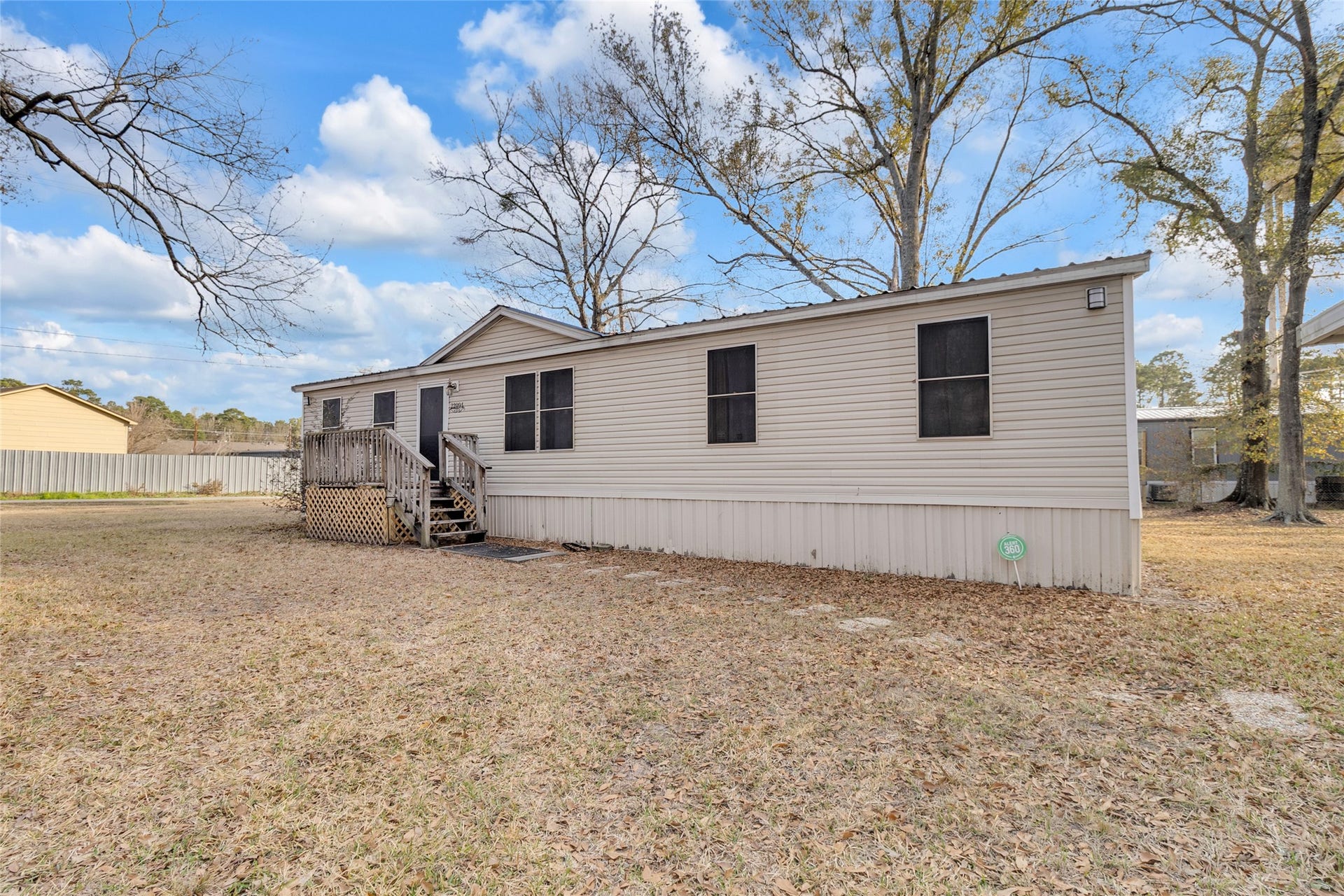 The exterior is a light-colored siding. Generous yard space provides ample room for outdoor activities and relaxation.