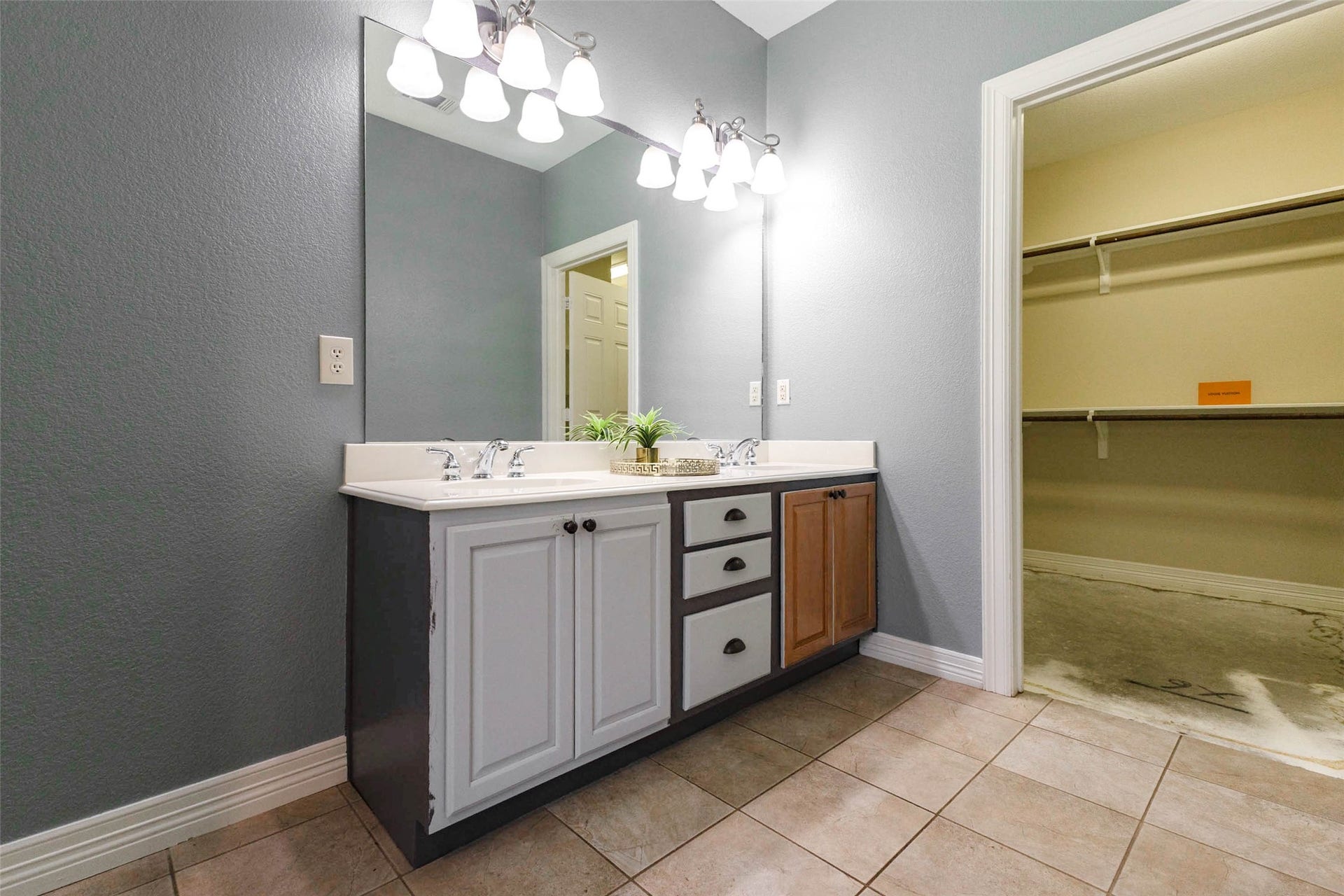 346 Skylark Street, Magnolia, TX 77355 Another view of the primary bath highlights the double-sink vanity with ample cabinet storage and a HUGE walk-in closet with built-in shelving and plenty of room for your wardrobe.