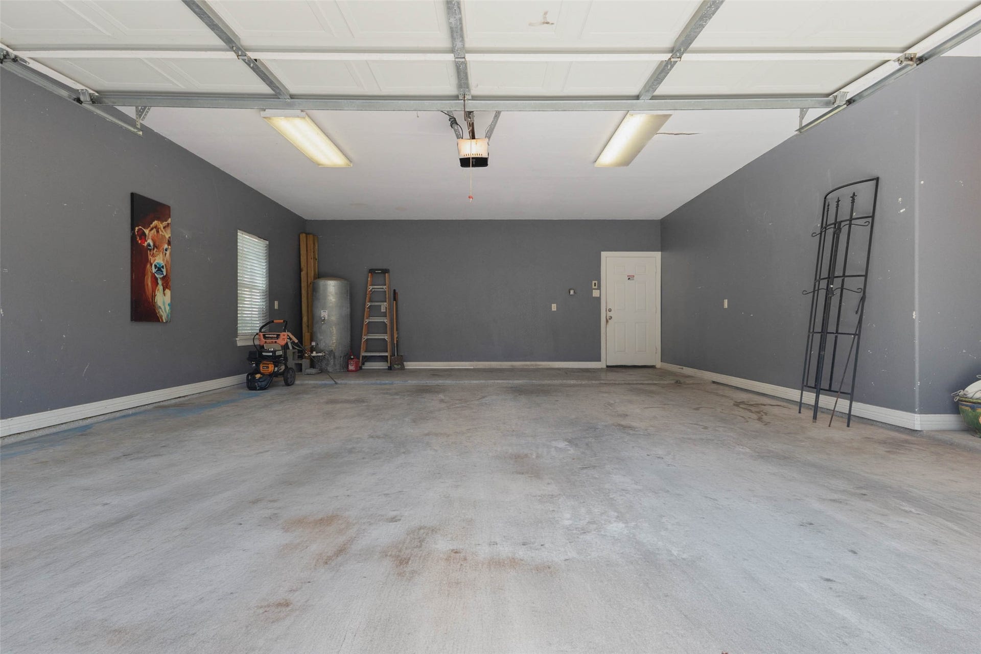 346 Skylark Street, Magnolia, TX 77355 The extra-large attached garage offers plenty of room for vehicles, tools, and additional storage, with ample space for a workbench or hobby area.