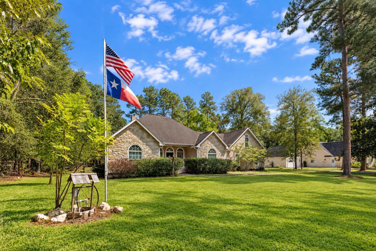 346 Skylark Street, Magnolia, TX 77355 What a beautiful approach to the home! An expansive front yard with plenty of space between the house and the street, framed by towering trees and proudly flying the American and Texas flags.