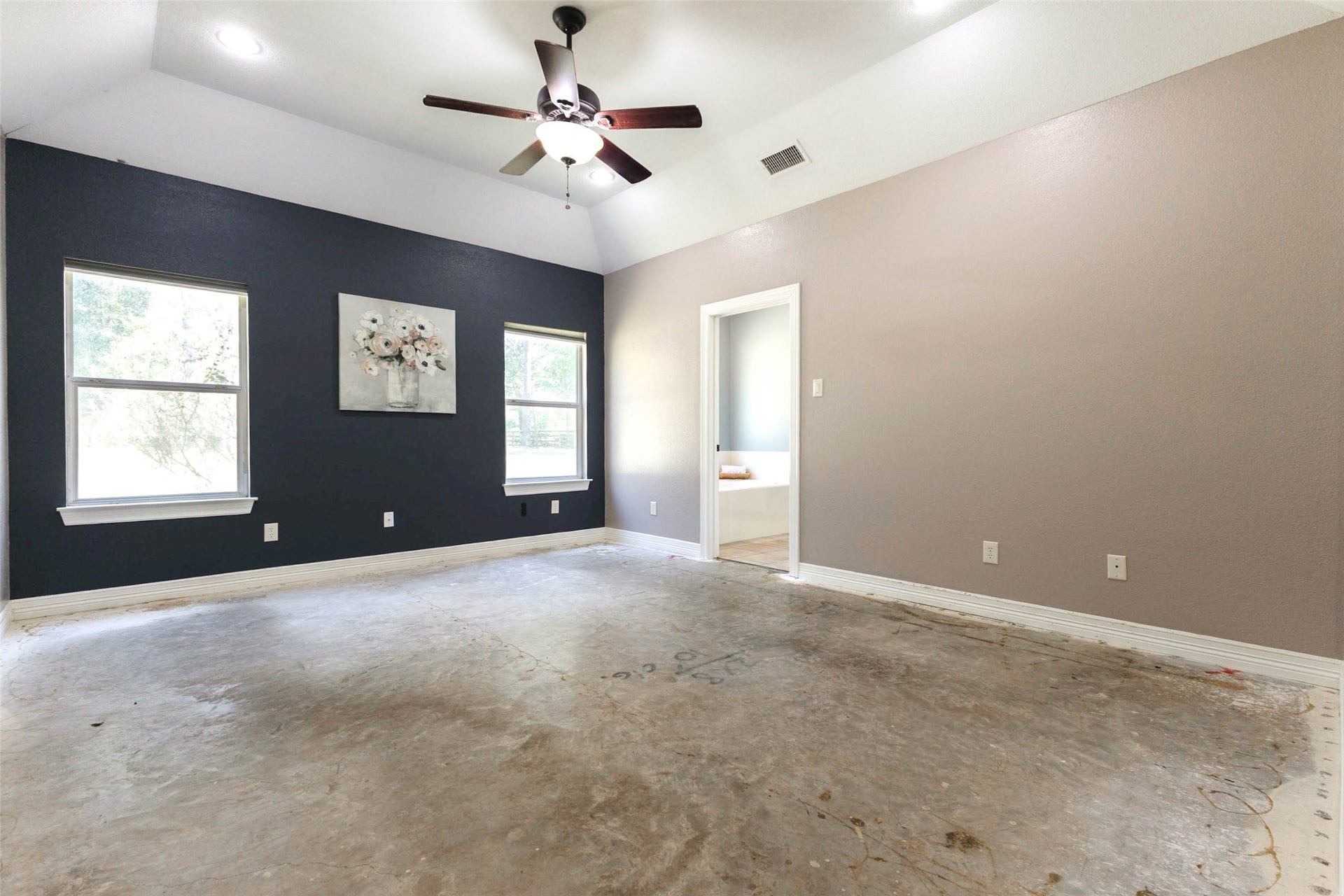 346 Skylark Street, Magnolia, TX 77355 The generously sized primary bedroom offers a vaulted ceiling, two windows with views of the surrounding trees, and direct access to the ensuite bath. A wonderful space to reimagine with your own choice of flooring and finishes.