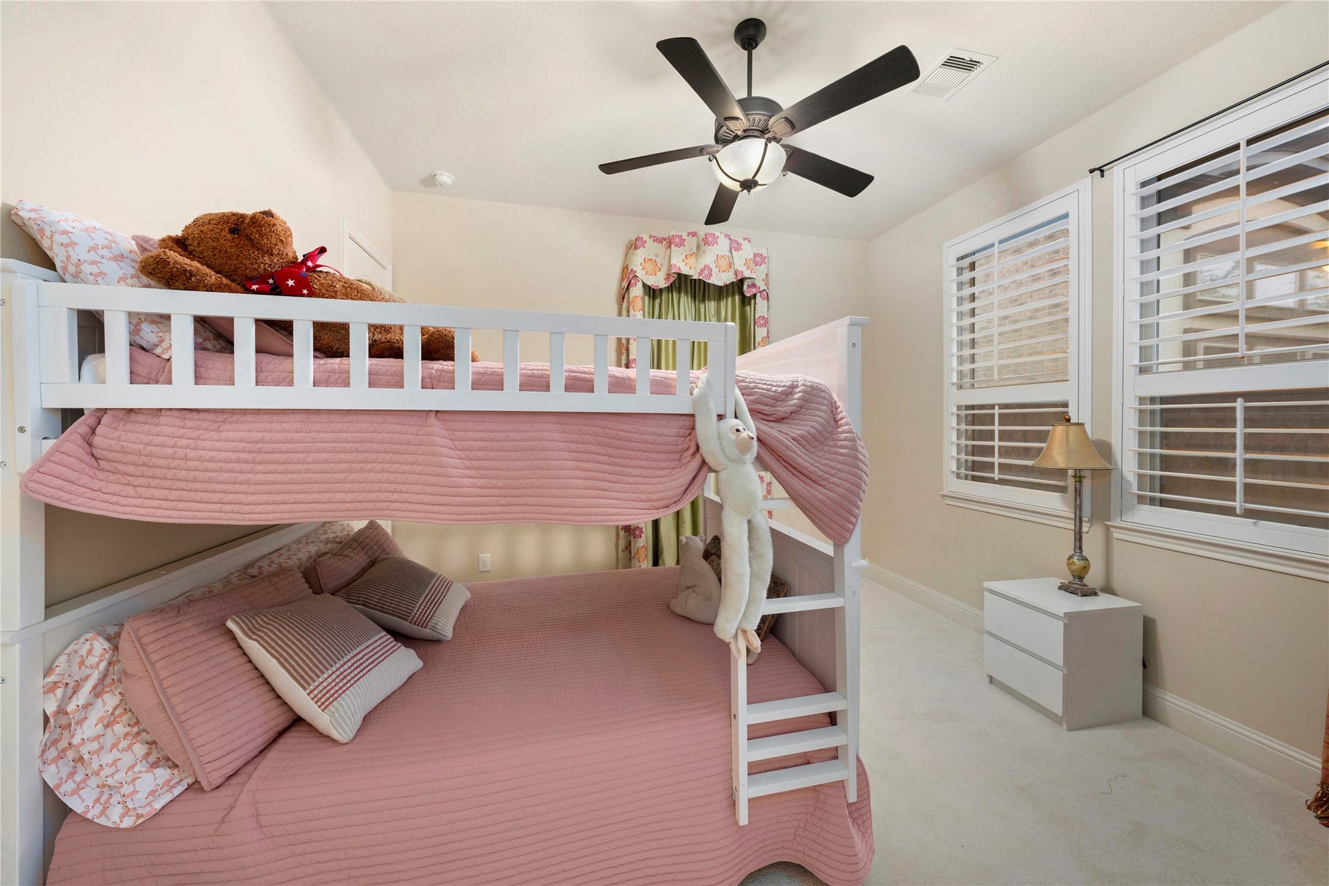 Spacious and bathed in natural light, this secondary bedroom features a convenient walk-in closet, perfect for comfortable living.
