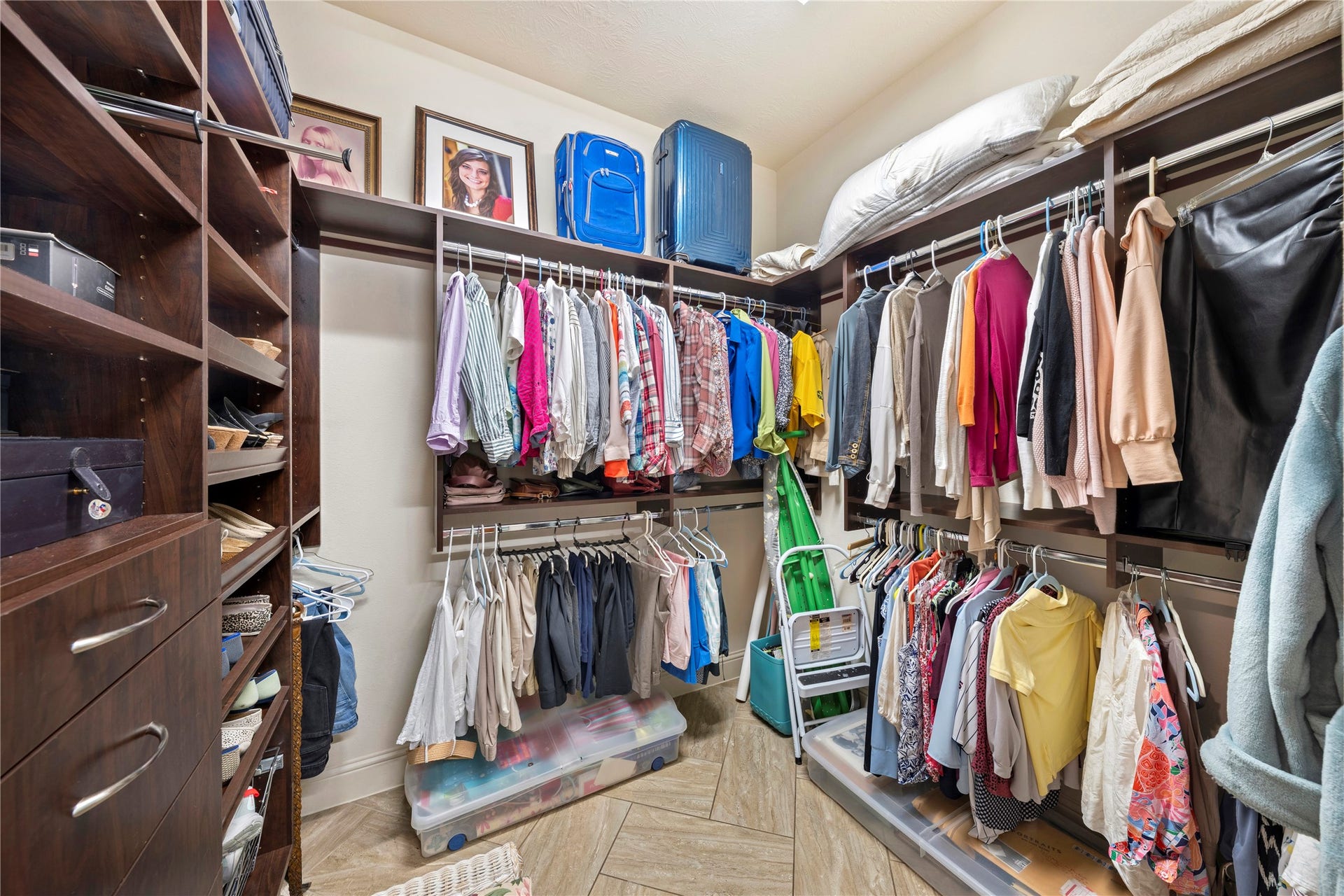 Discover the luxury of a massive primary closet offering ample space with personalized sides for each person.