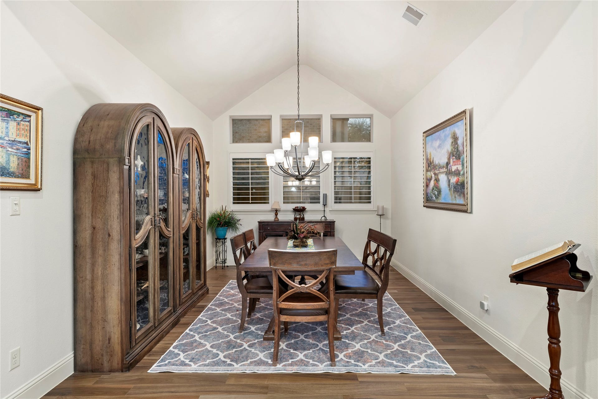 Expansive dining room perfect for showcasing your grand furniture collection, with elegant lighting and ample natural light.