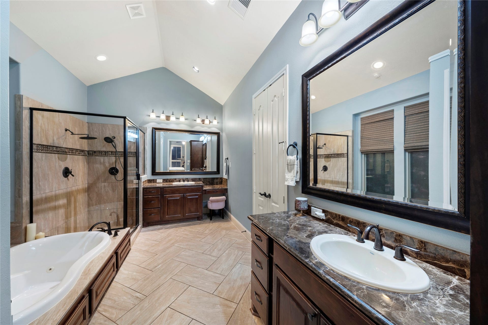 Indulge in the luxury of a primary bathroom featuring a large soaking tub, separate shower, and dual vanities for a perfect blend of style and functionality.