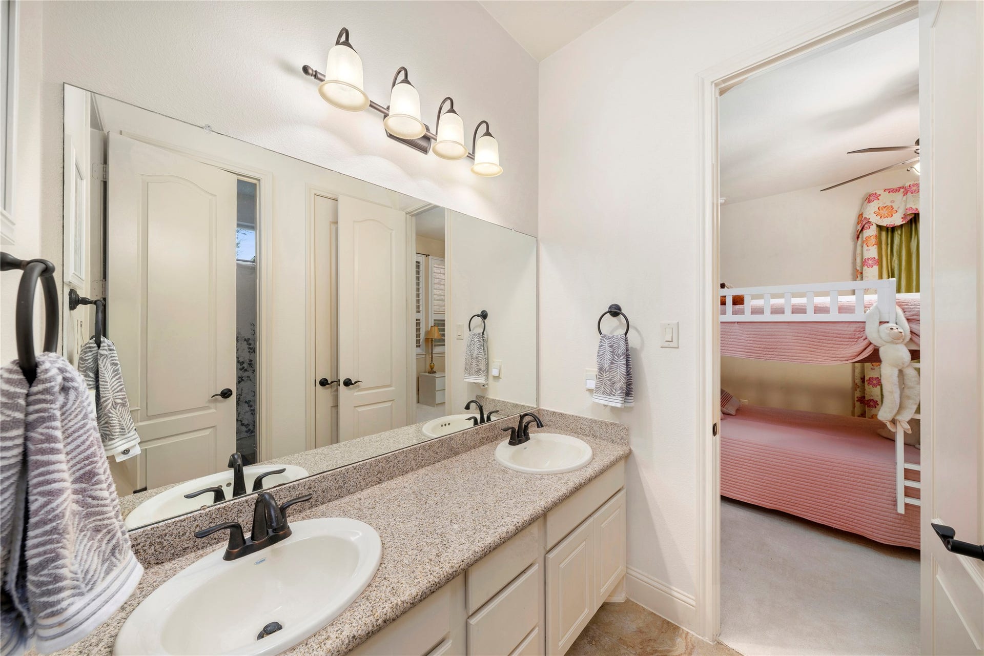 Experience the convenience of double vanity sinks, perfect for letting the kids get ready simultaneously in style.