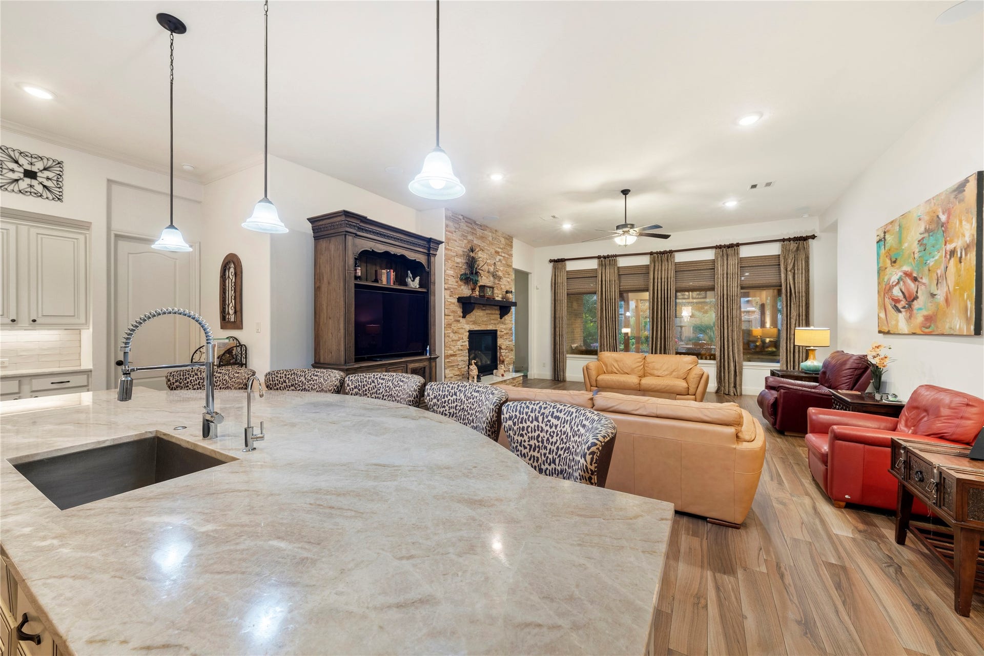 Experience seamless living in this open kitchen and family room combination, highlighted by elegant Italian tile and a striking stone gas log fireplace.