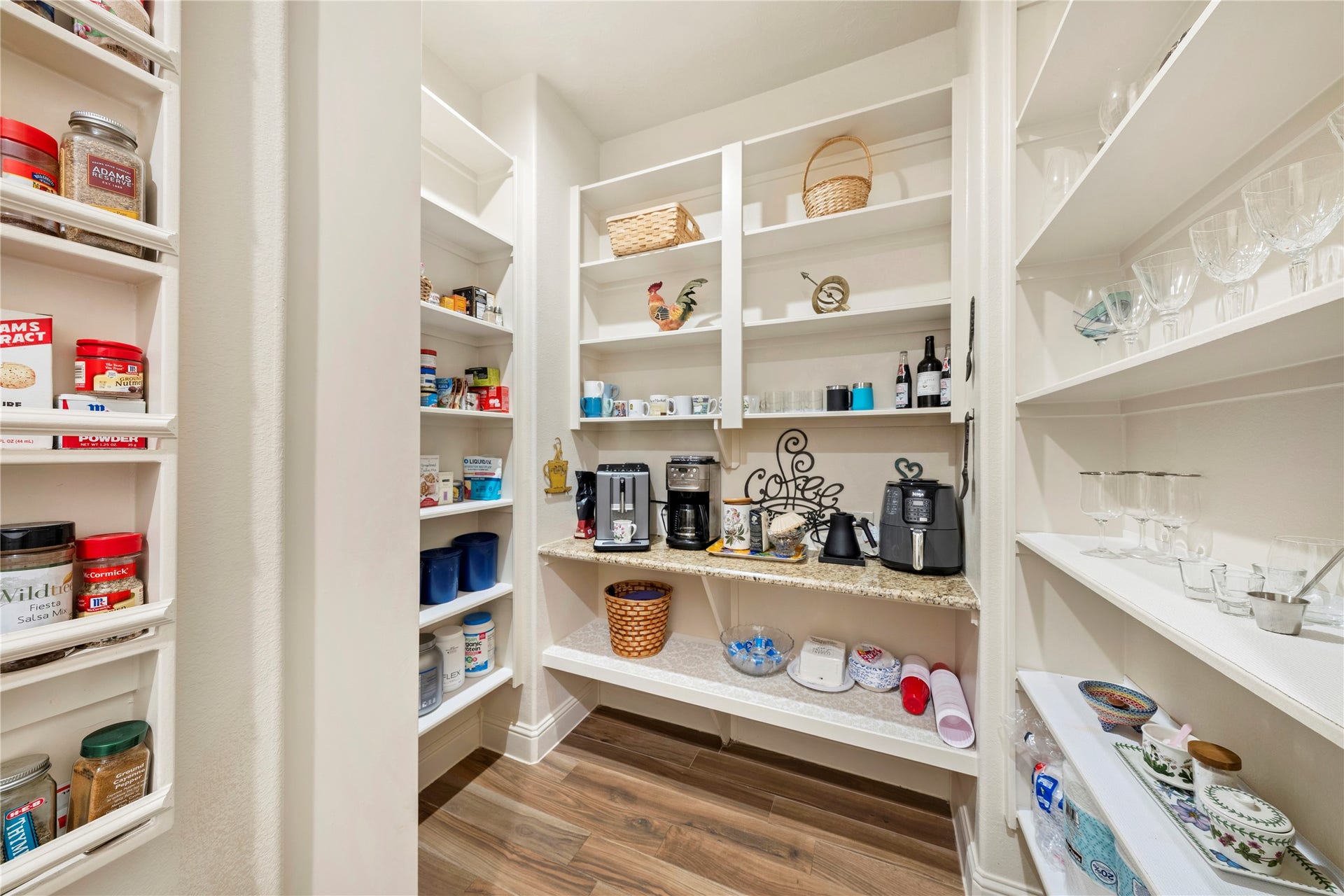 Discover the kitchen's hidden gem with a spacious pantry, perfect for storing all your small appliances and featuring a convenient coffee bar.