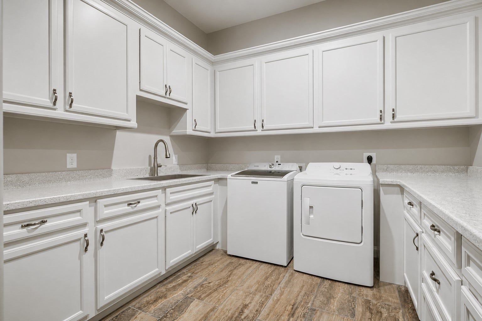 11865 Hope Lane, Magnolia, TX 77354 This well-designed laundry room offers exceptional functionality with a utility sink, ample storage, and plenty of workspace for all your household needs.