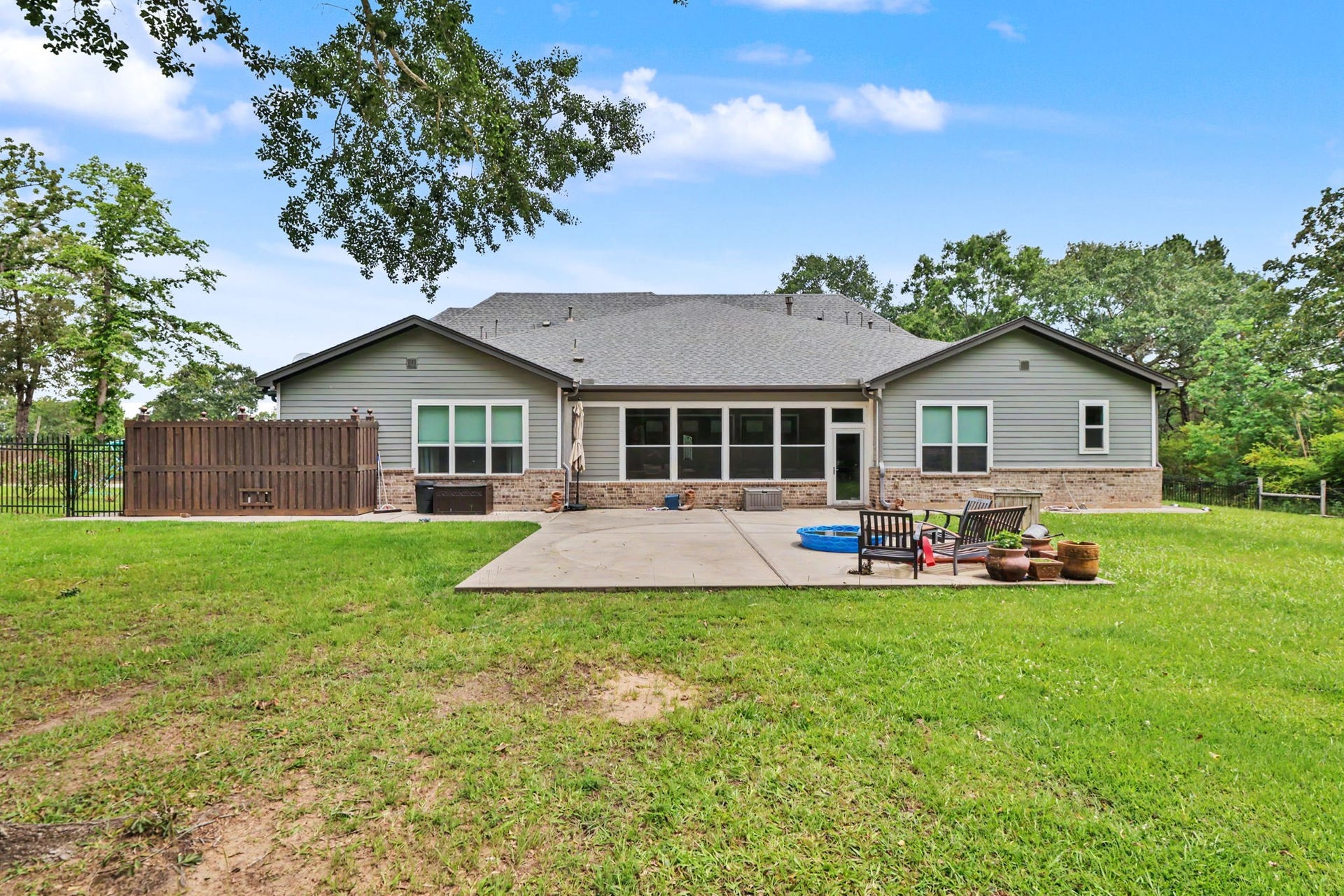 11865 Hope Lane, Magnolia, TX 77354 Relax and unwind on this spacious patio while taking in the serene views of the backyard and surrounding acreage.